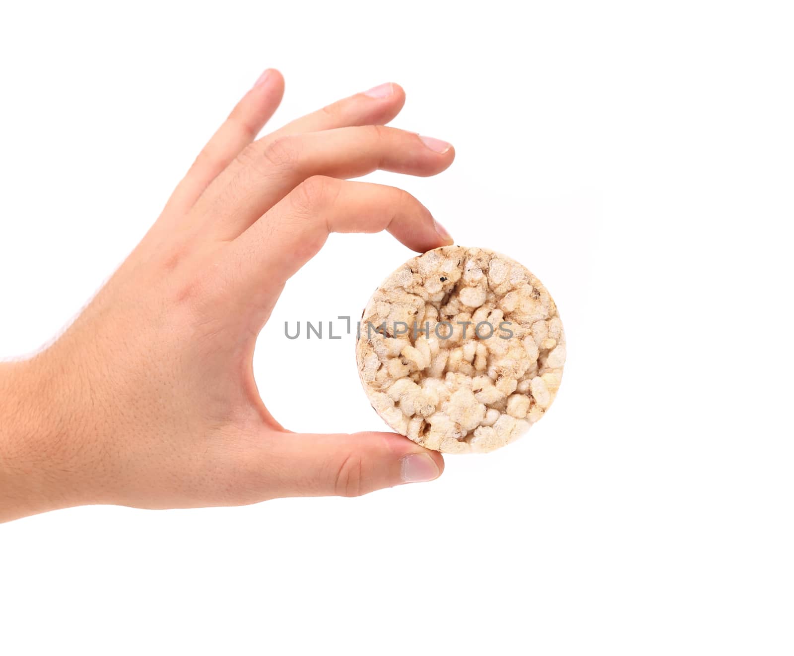Hand holds corn crackers. Close up. White background.