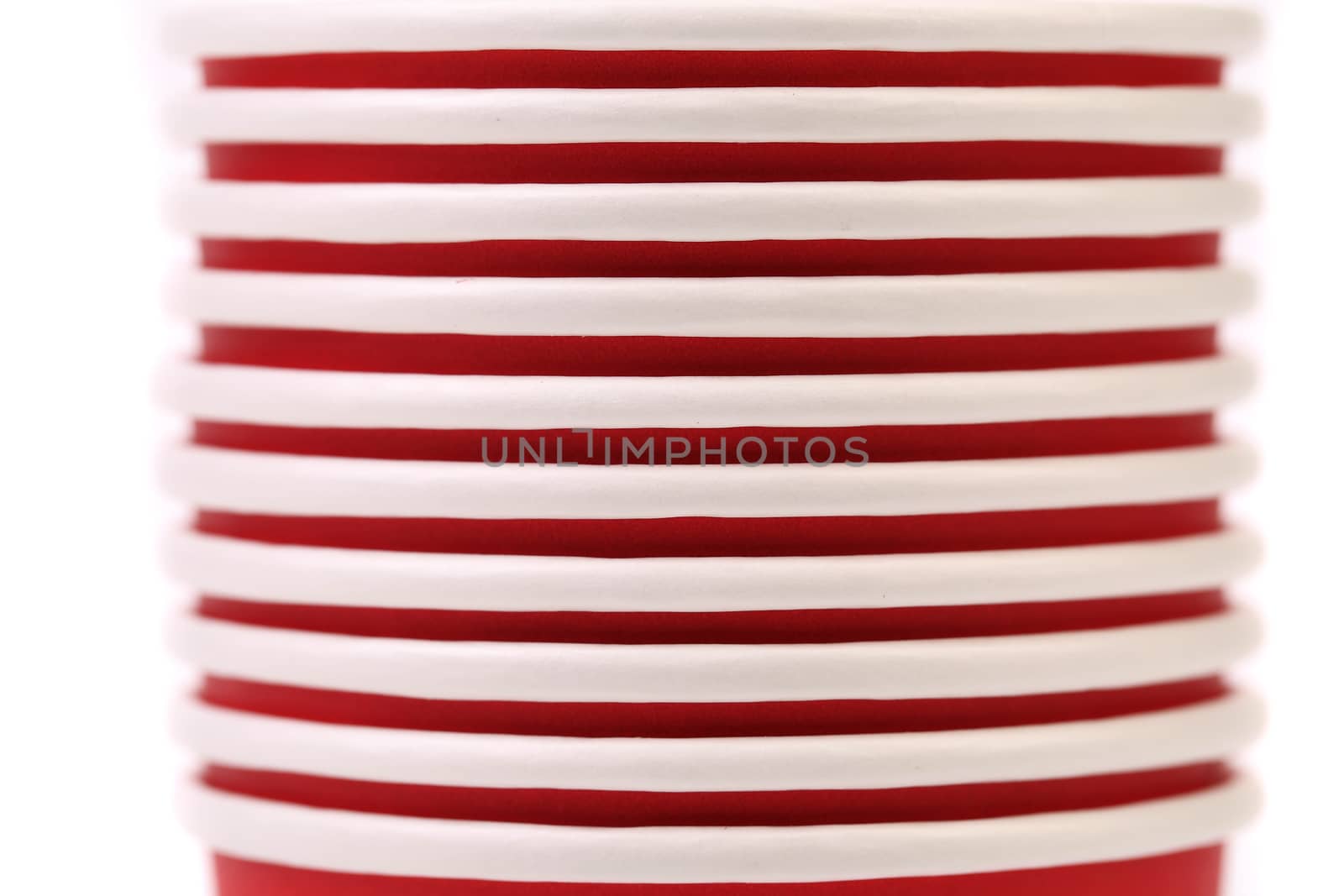 Pile of colorful paper coffee cup. Close up. White background.