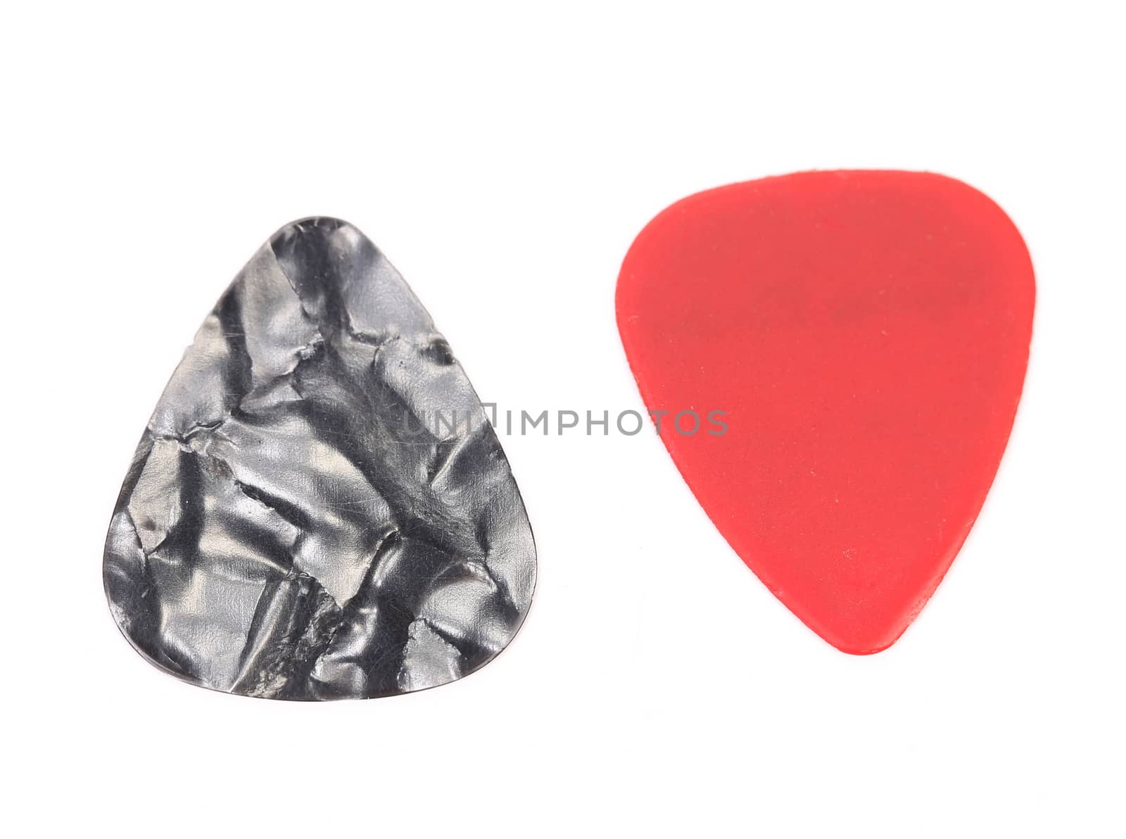 Red and dark plastic guitar plectrums, isolated on white