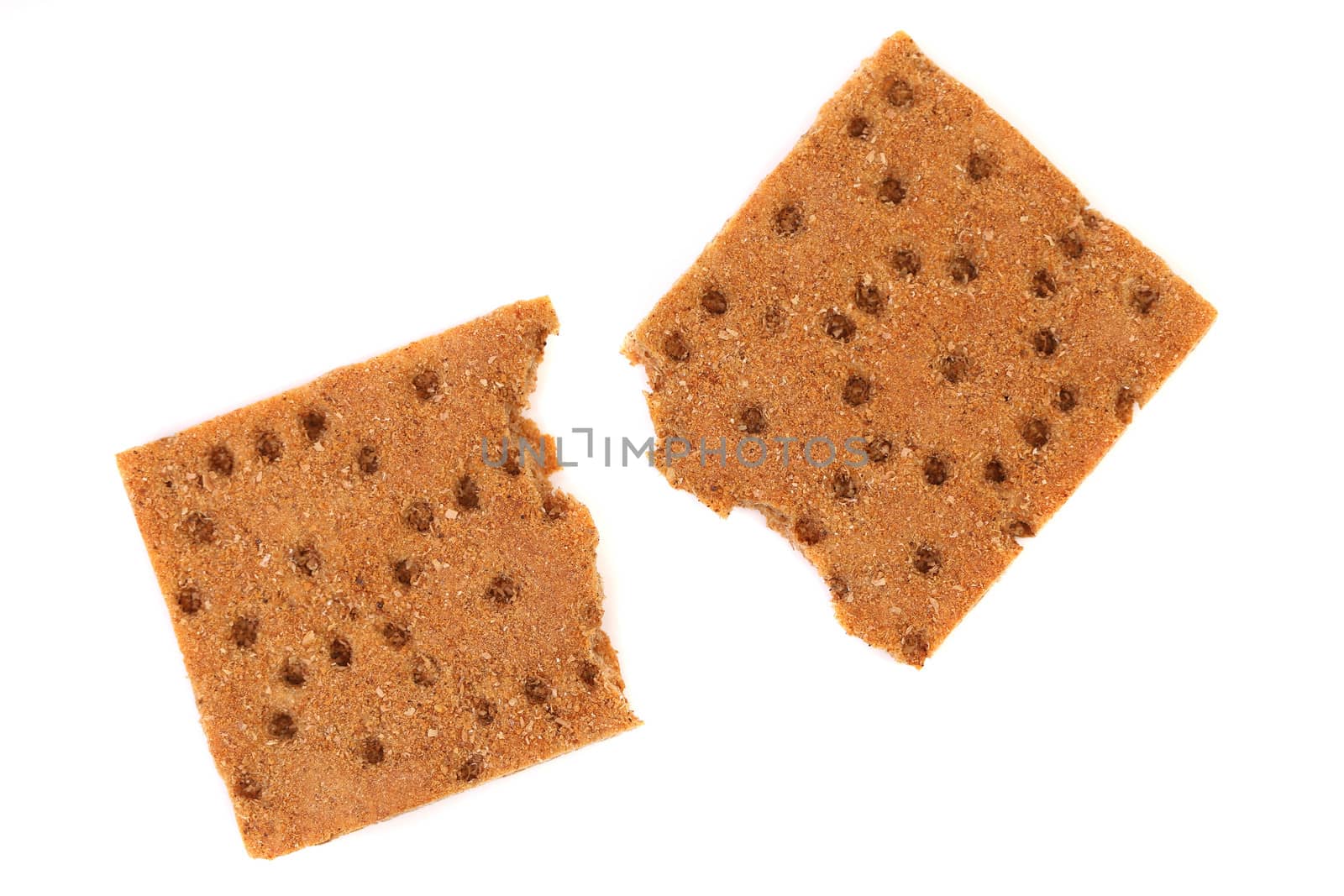 Broken whole grain crisp bread. White background.