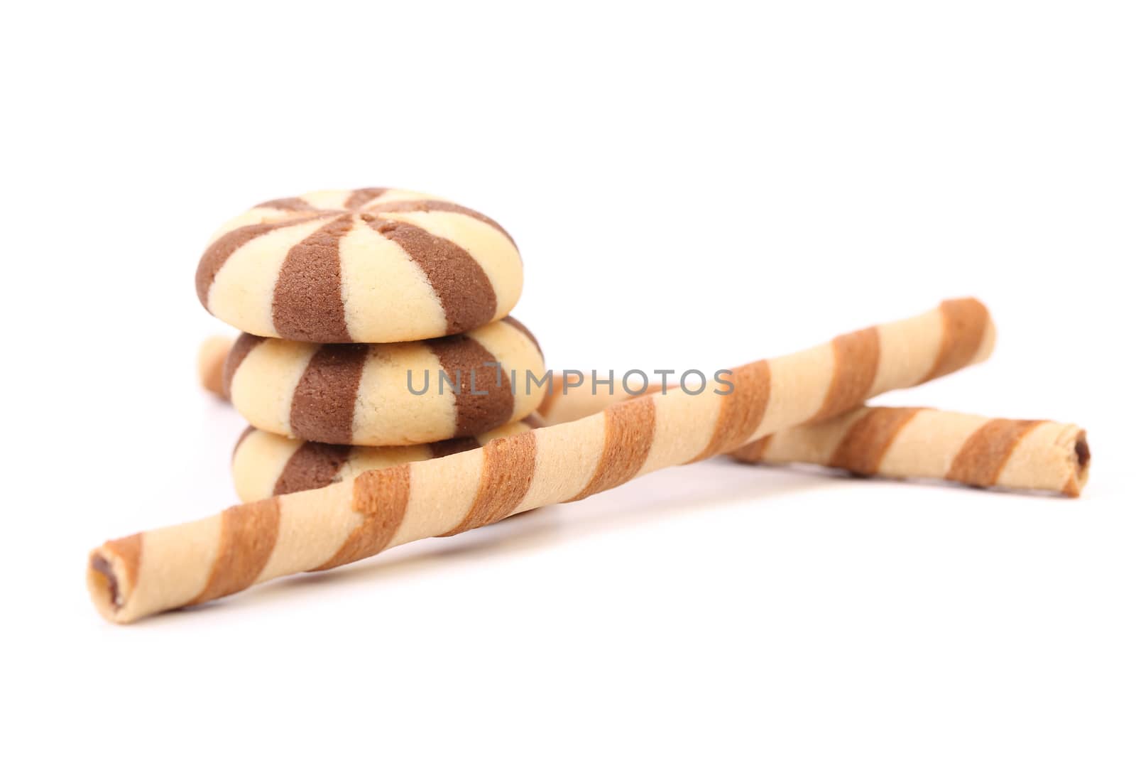 Chocolate striped wafer rolls and stake biscuits. White background.
