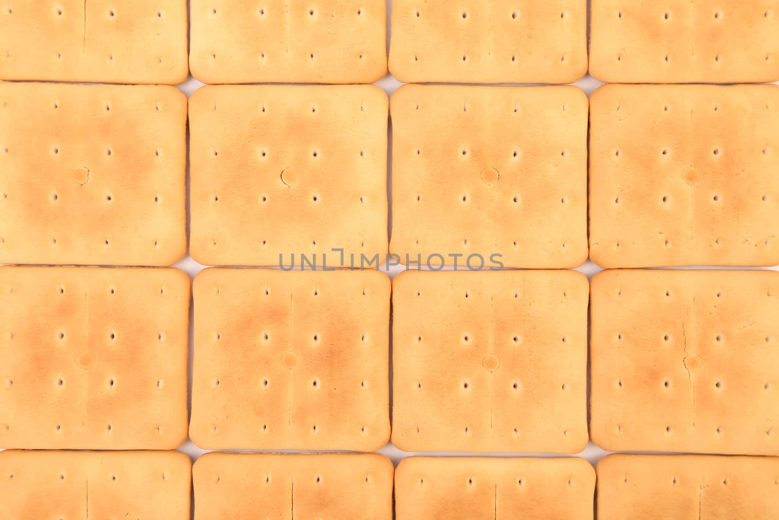 Background of saltine soda cracker. Wclose up.