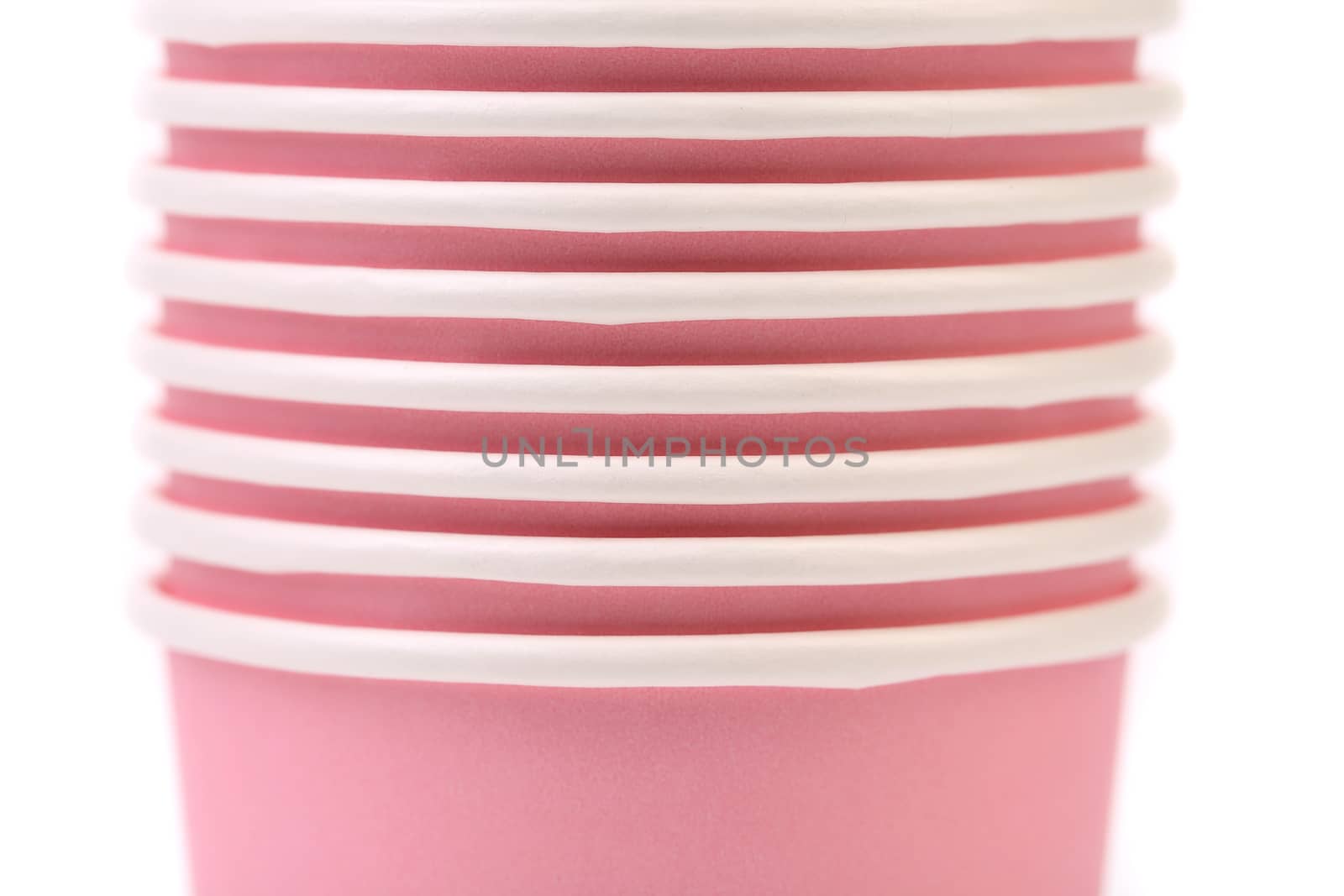 Pile of colorful paper coffee cup. Close up. White background.