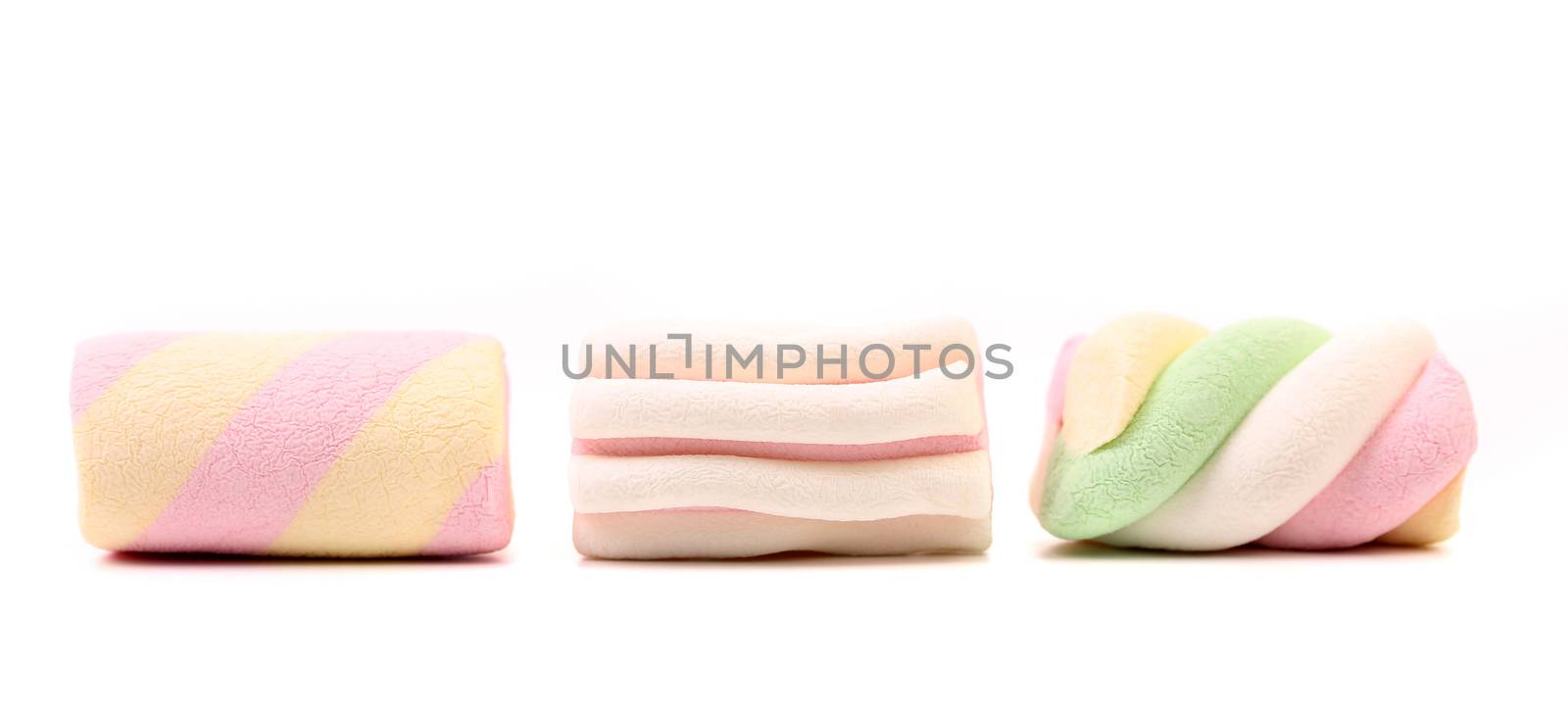 Three different colorful marshmallow. Close up. White background.
