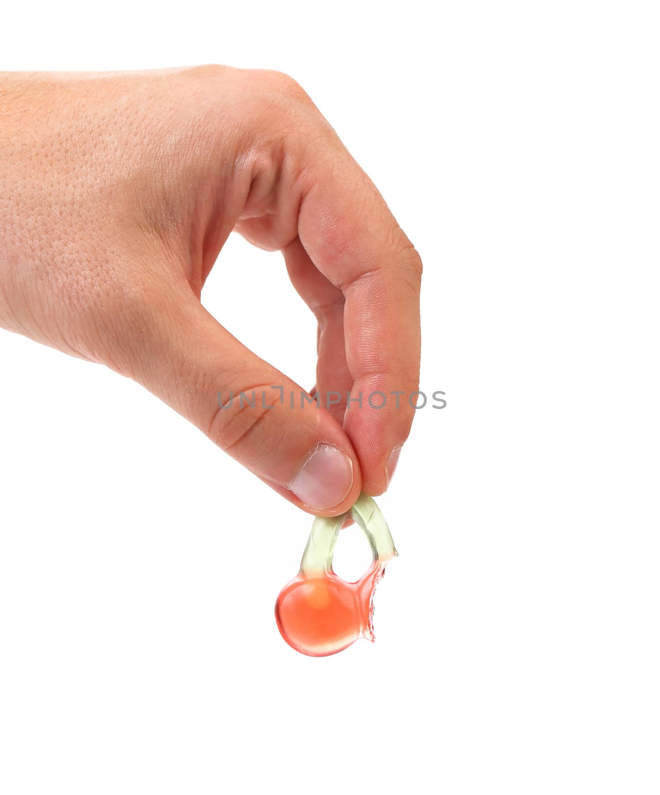 Hand hold fruit jelly in form of cherries. White background.