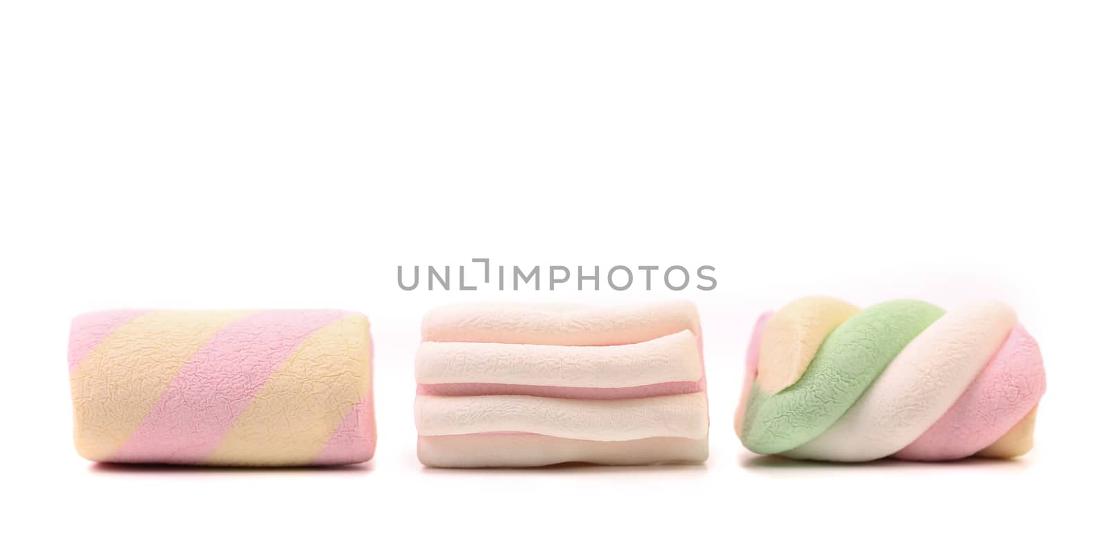 Three colourful marshmallow. Close up. by indigolotos