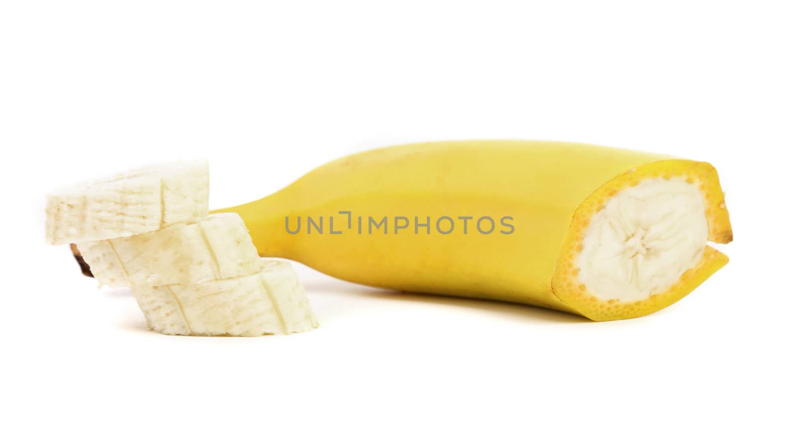 Half of banana and slices. White background.