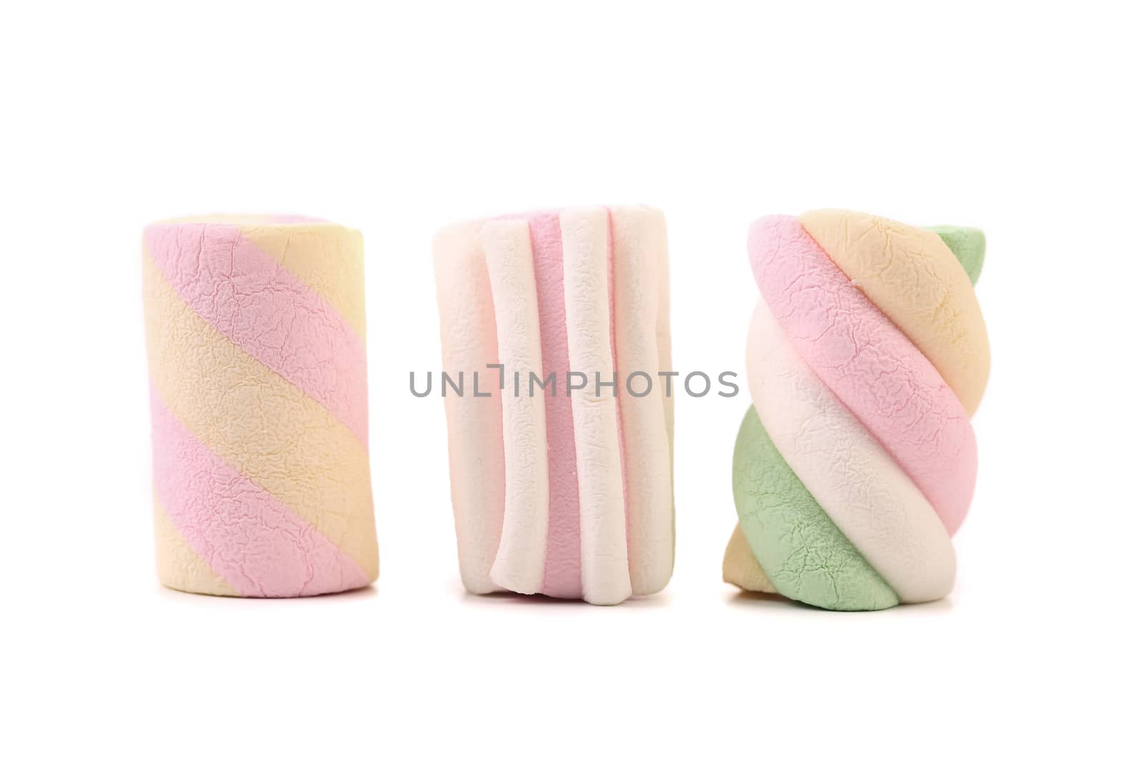 Three colourful marshmallow. Close up. White background.
