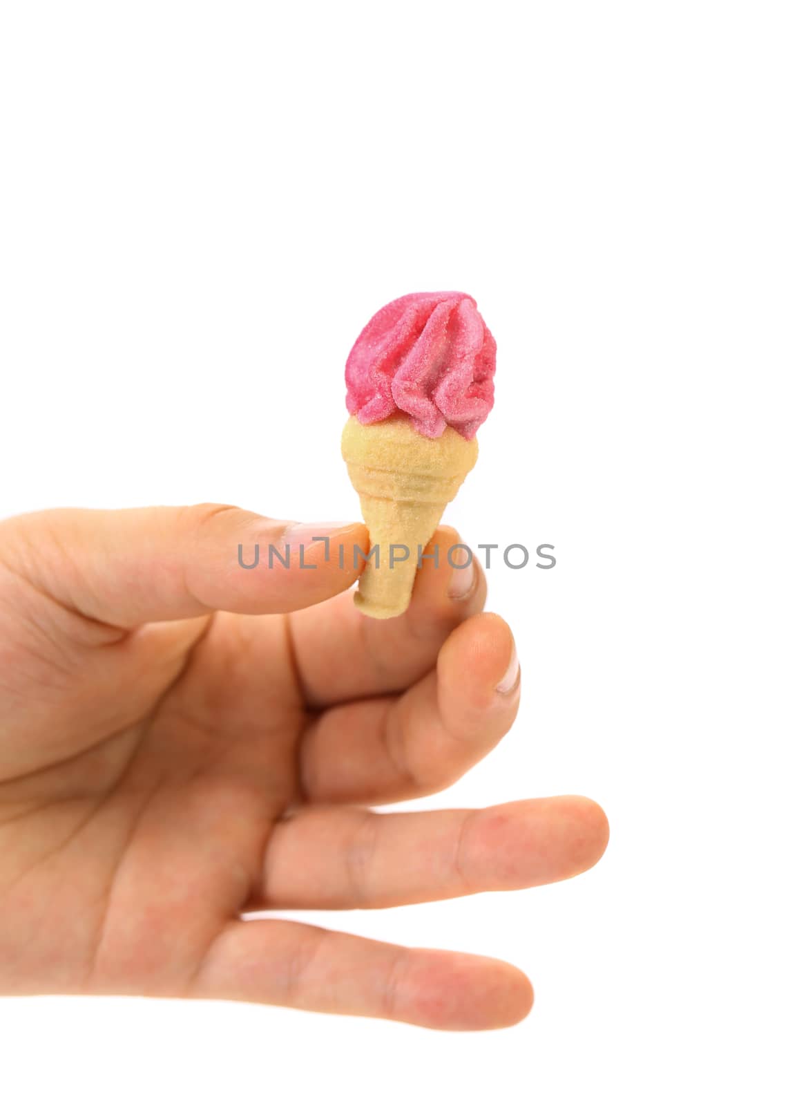 Hand holds arshmallow in form of ice cream. White background.