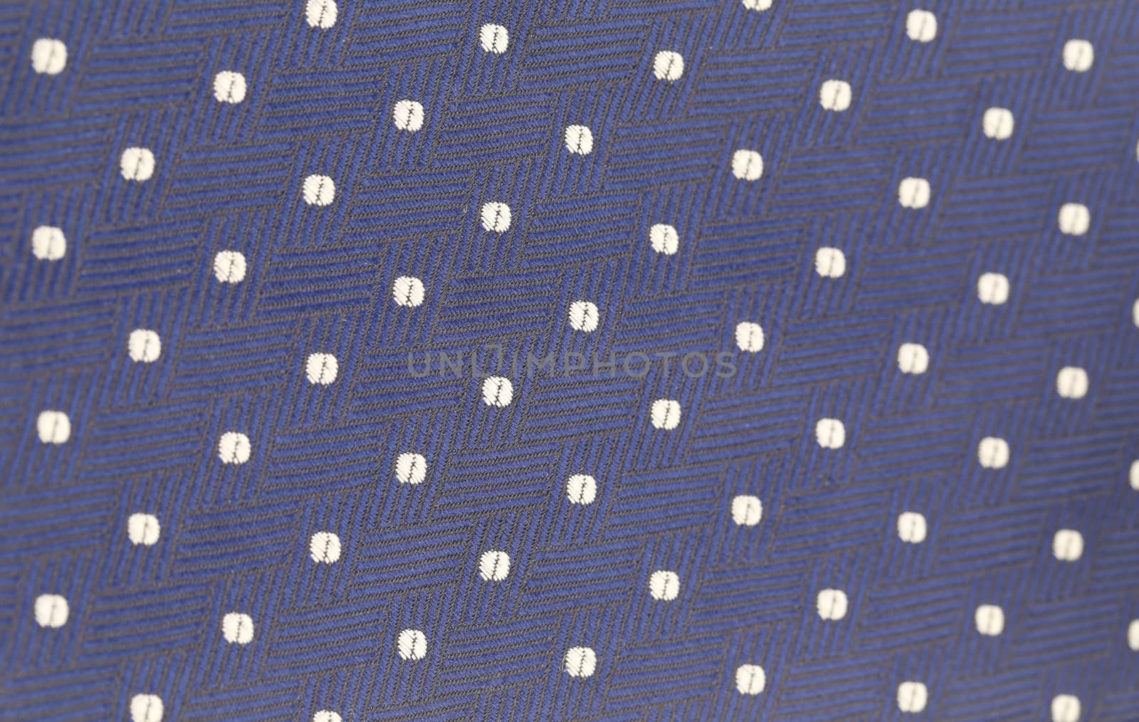 Background of blue tie with white speck. Texture.