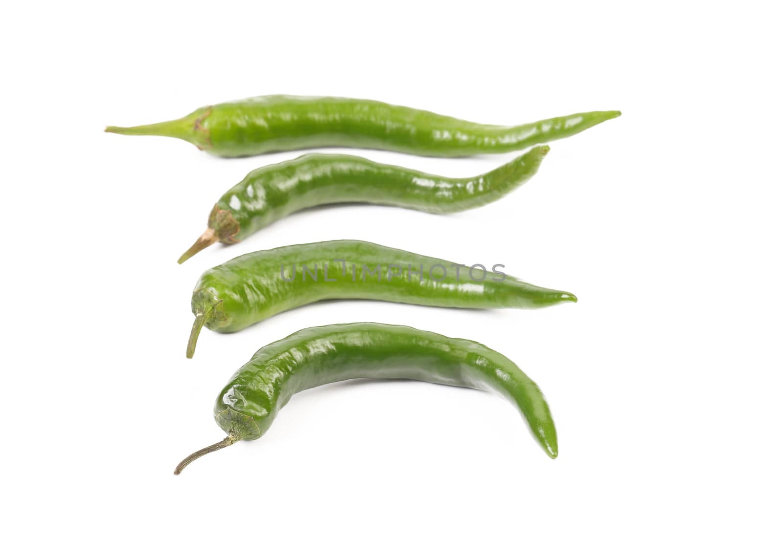 Four green peppers isolated on a white background