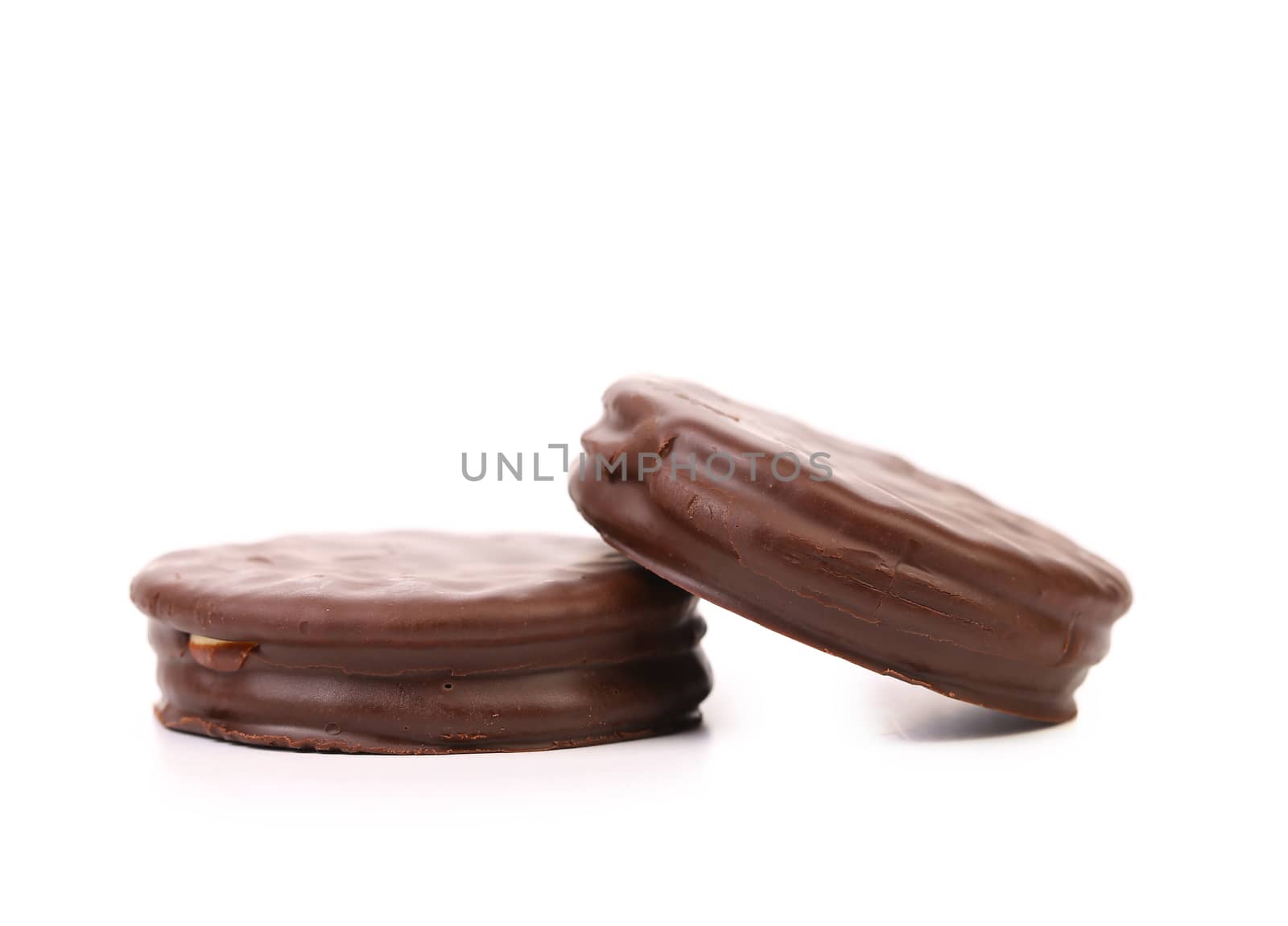 Two biscuit sandwich with chocolate. White background.