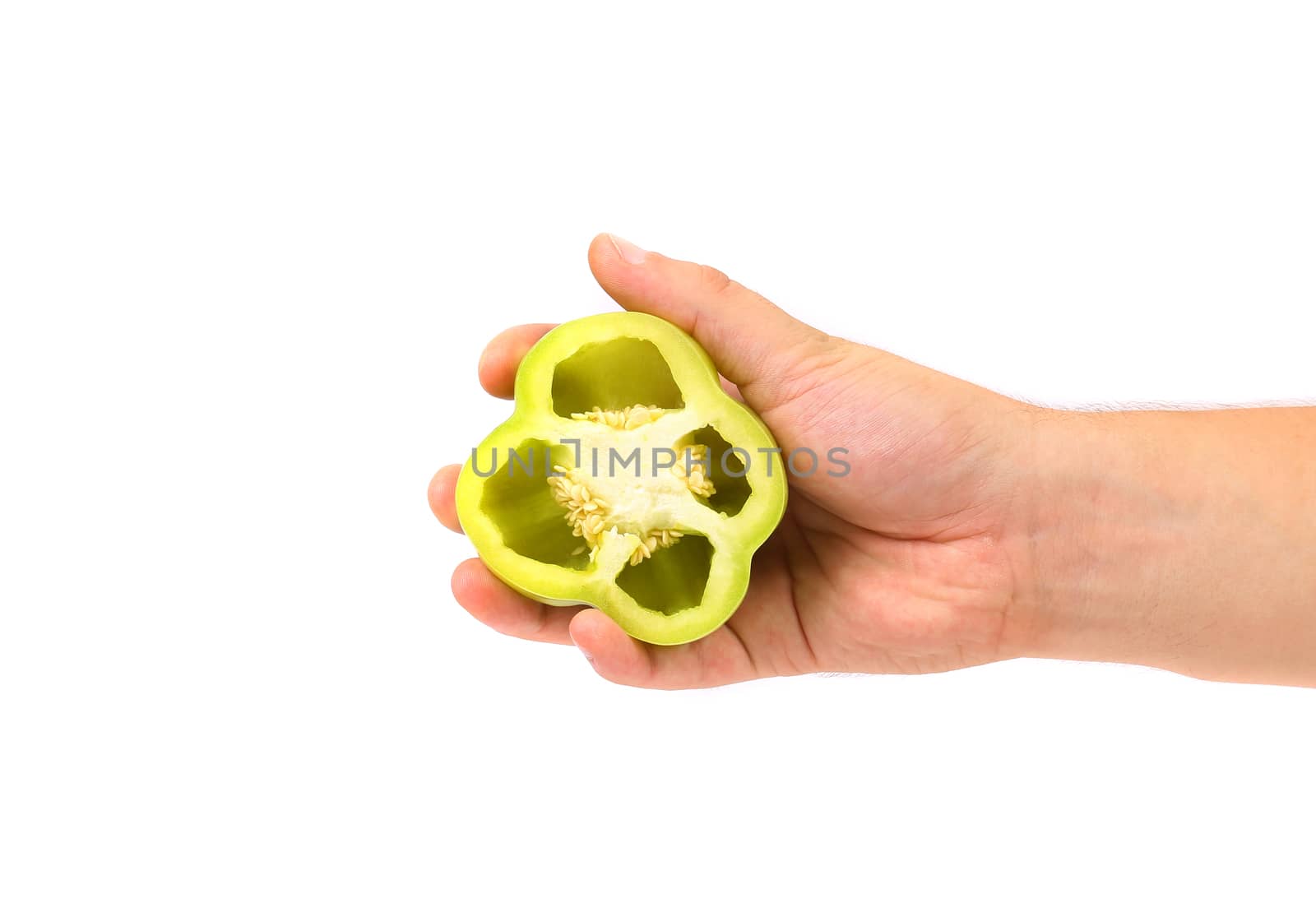 Hand holds half of green pepper. White background.