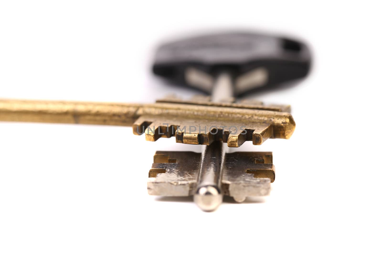 Golden and dark keys. One above the other. White background.