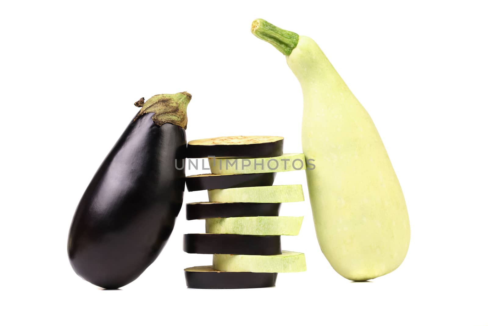 Stack of slices. Zucchini and black eggplant. White background.