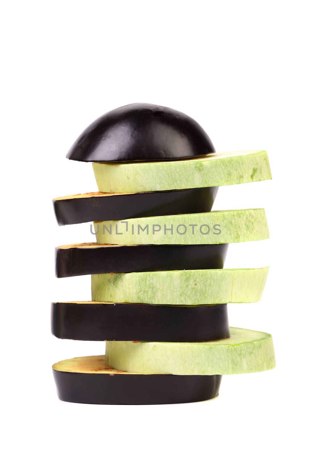 Slices of zucchini and black eggplant. White background.