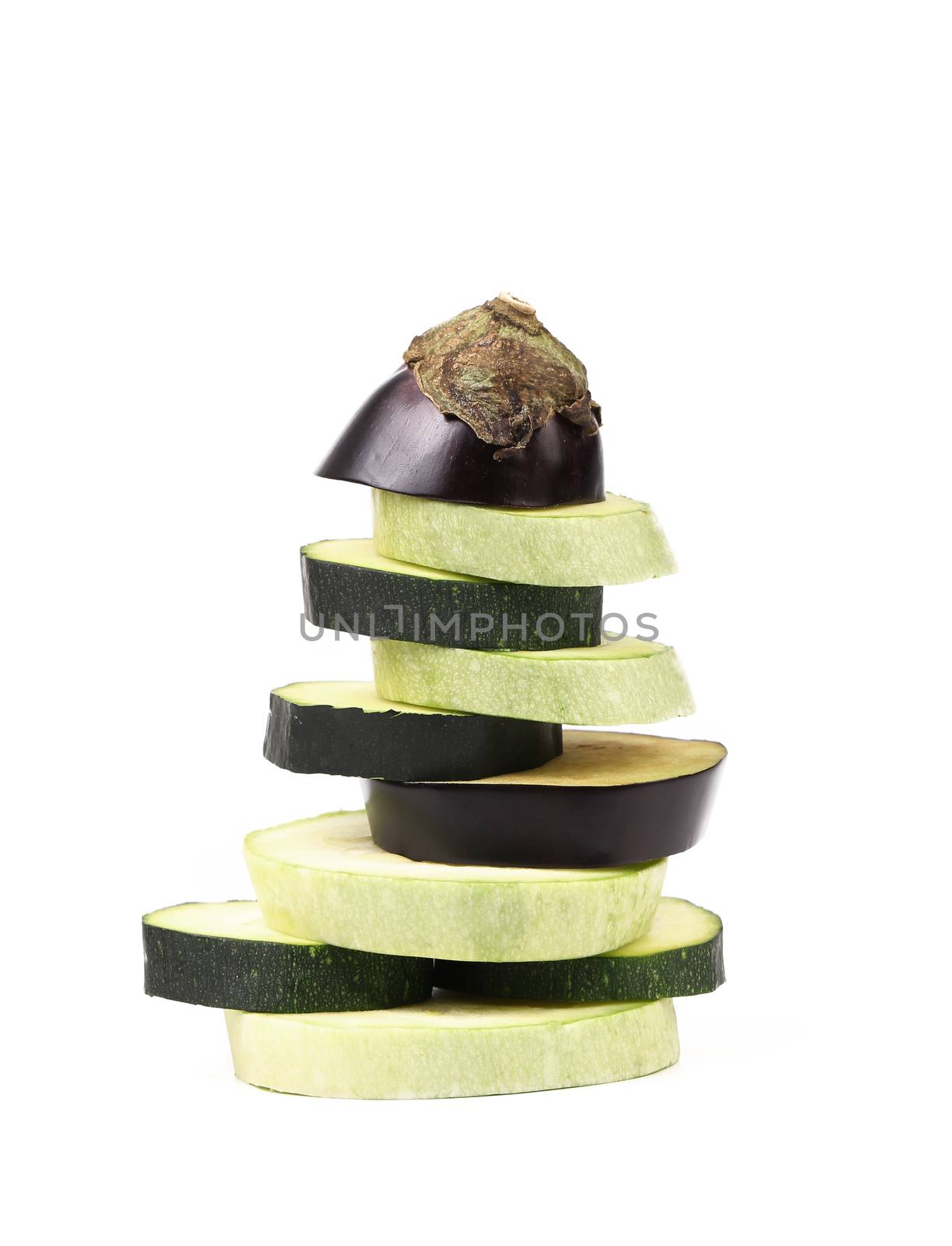 Stack of slices vegetable marrow and eggplant. Wite background.