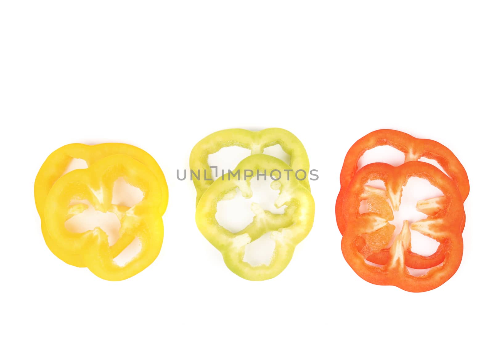 Multi-colour slices of pepper isolated on a white background.