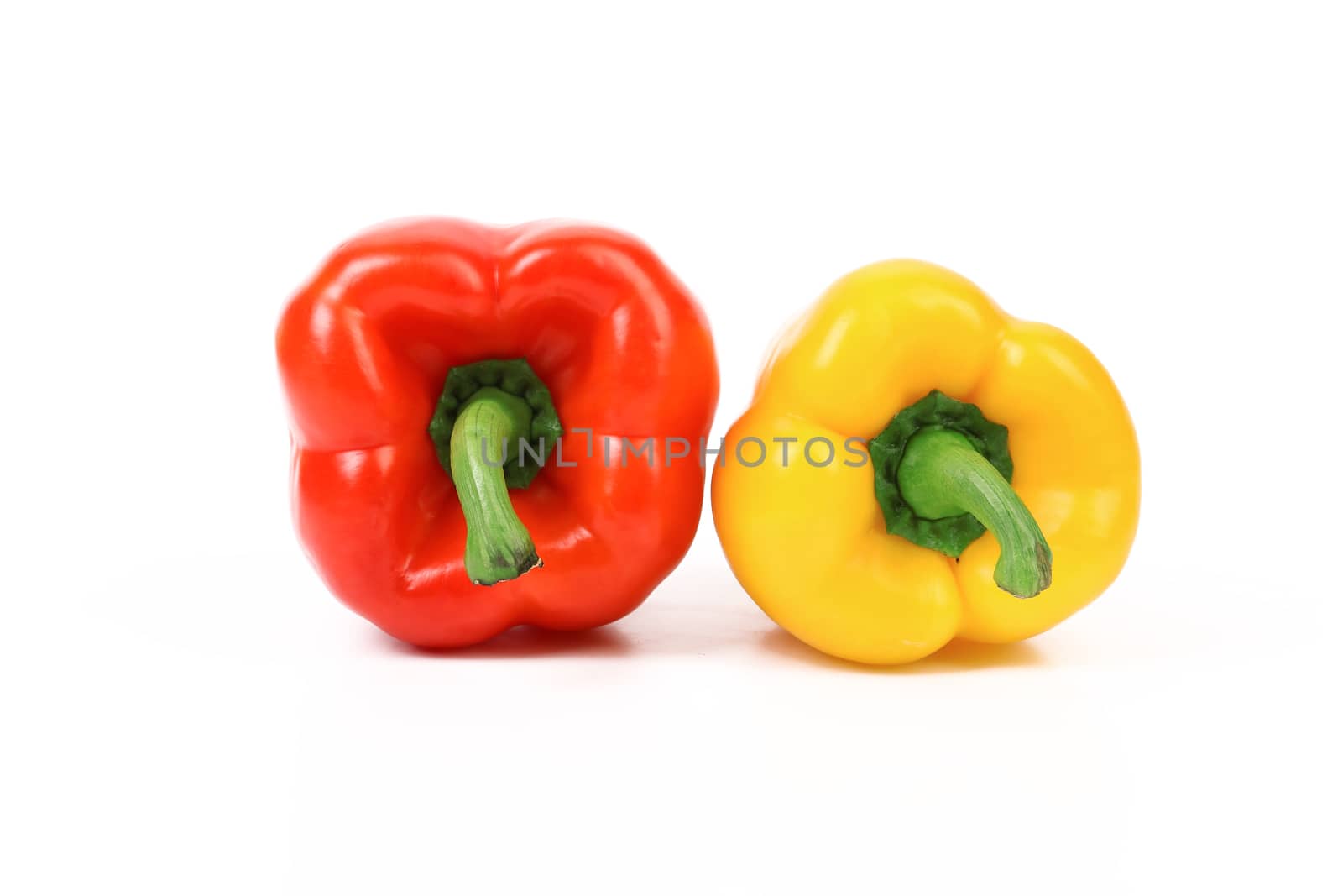 Tails of red and yellow peppers isolated on a white background