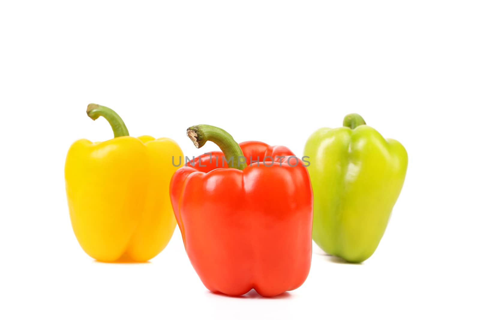 Three colored peppers isolated on a white background