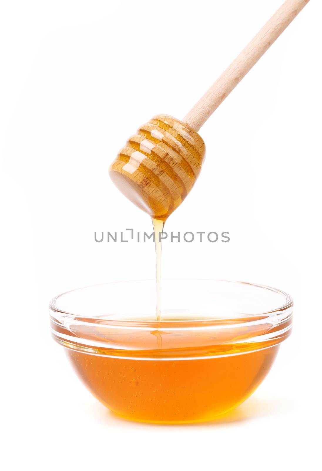 Bee honey with wooden dipper. Honey's dessert - honey stick on golden background.
