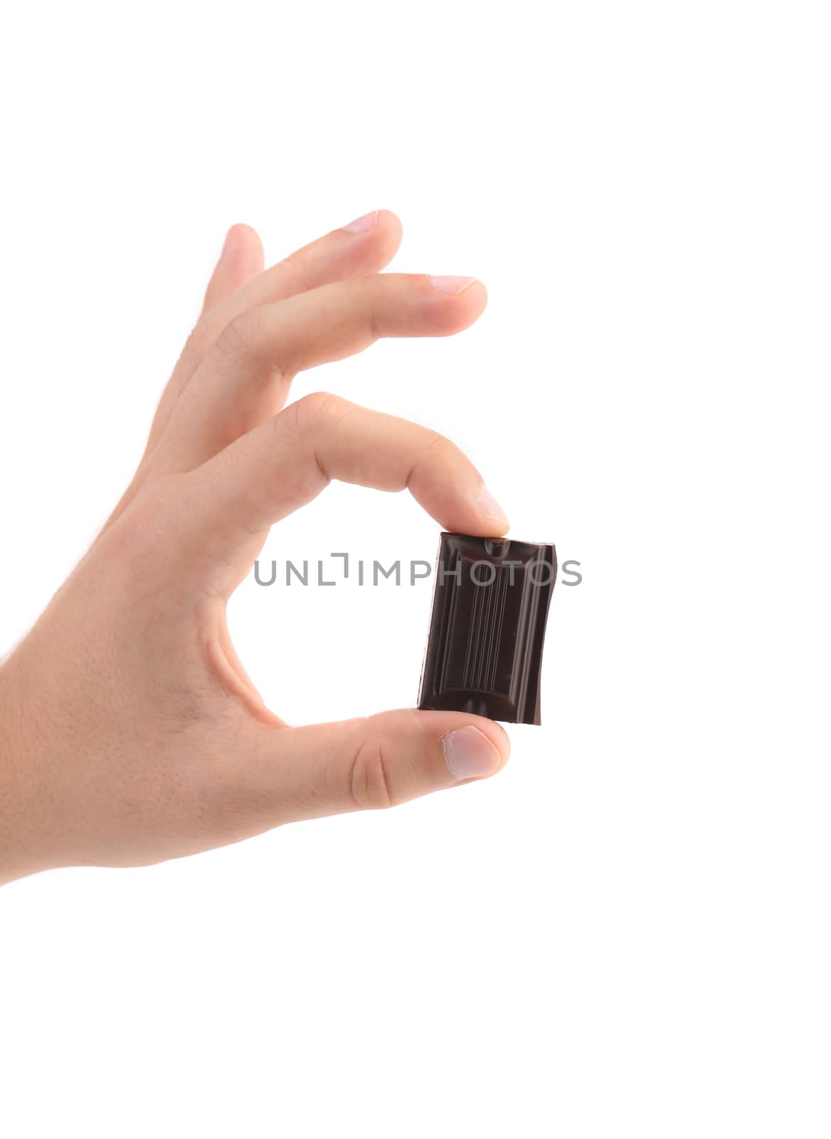 Hand holds chocolate bar. Close up. White background.