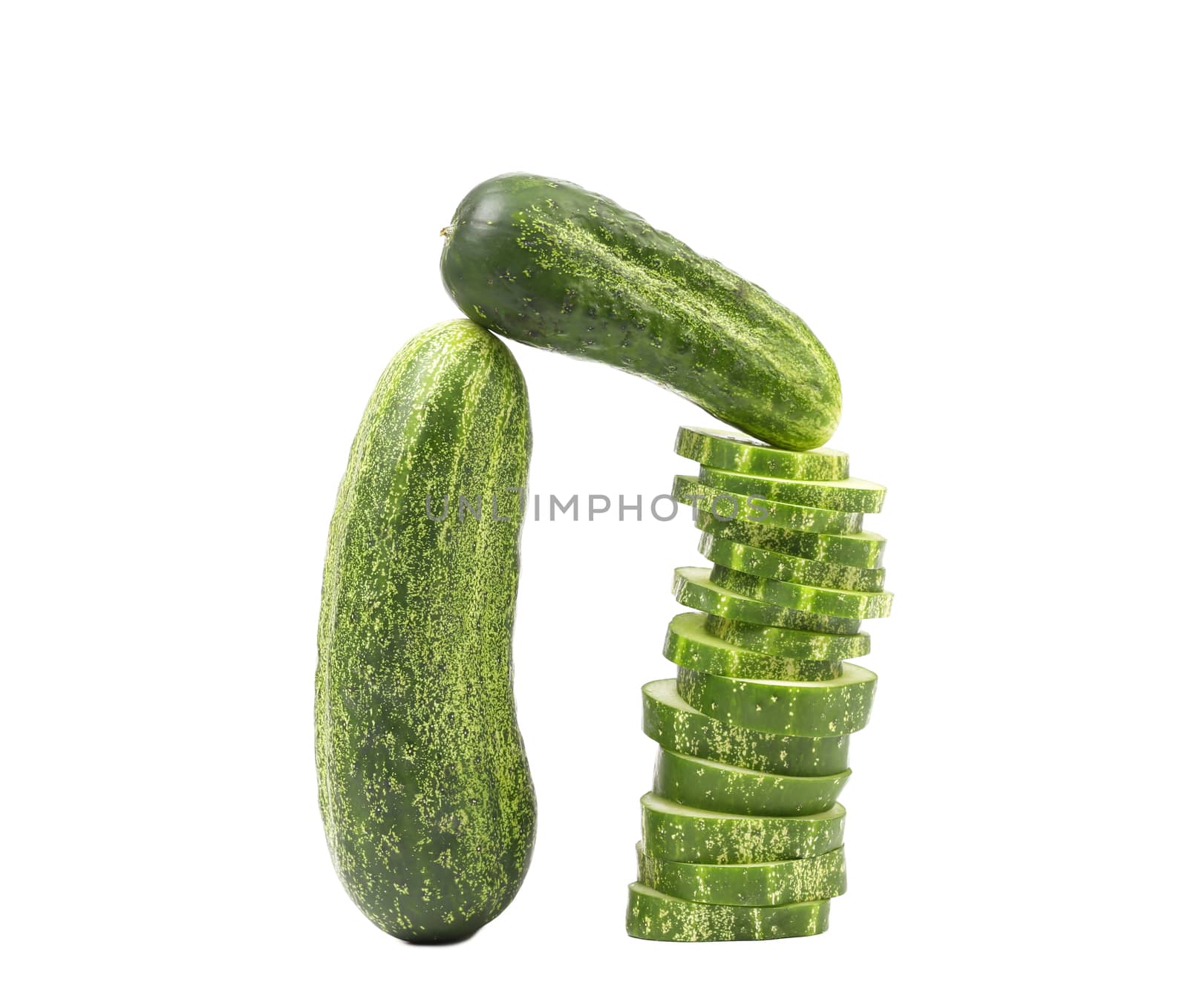 Arch. Cucumbers and stack of slices. White background.