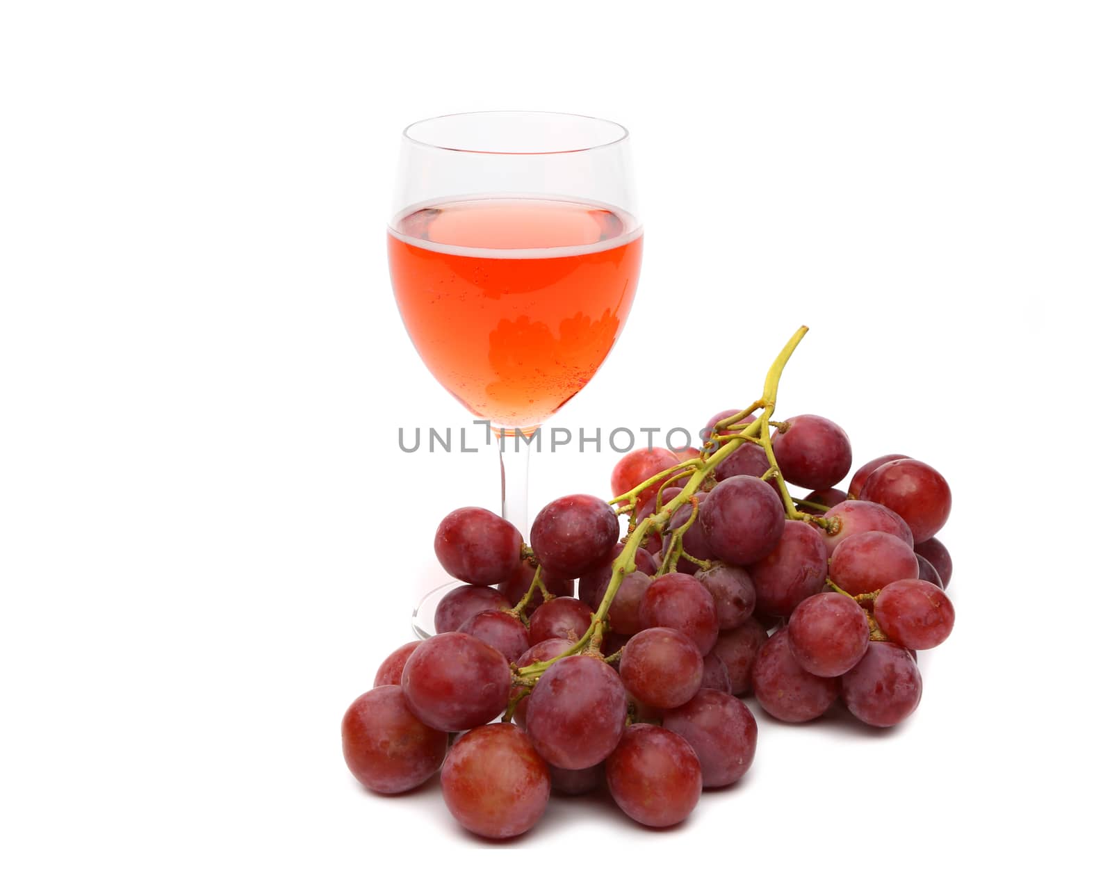 glass of wine and grapes isolated on the white background