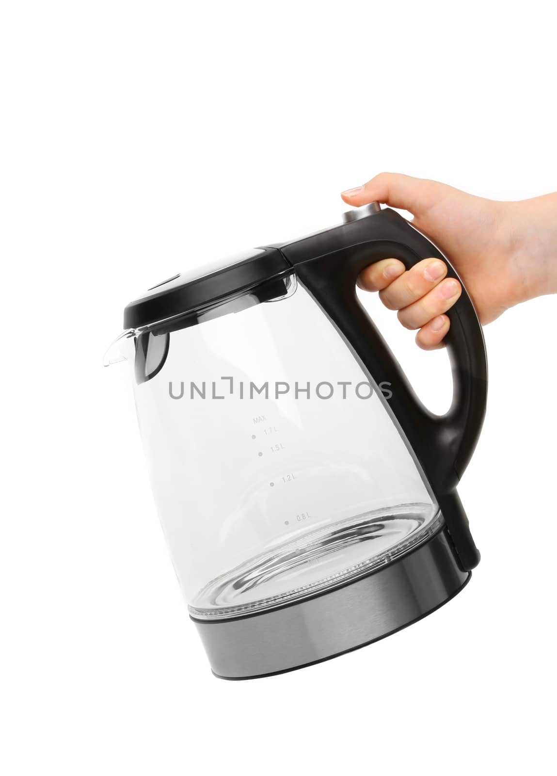 Hand holds glass electric kettle. White background.