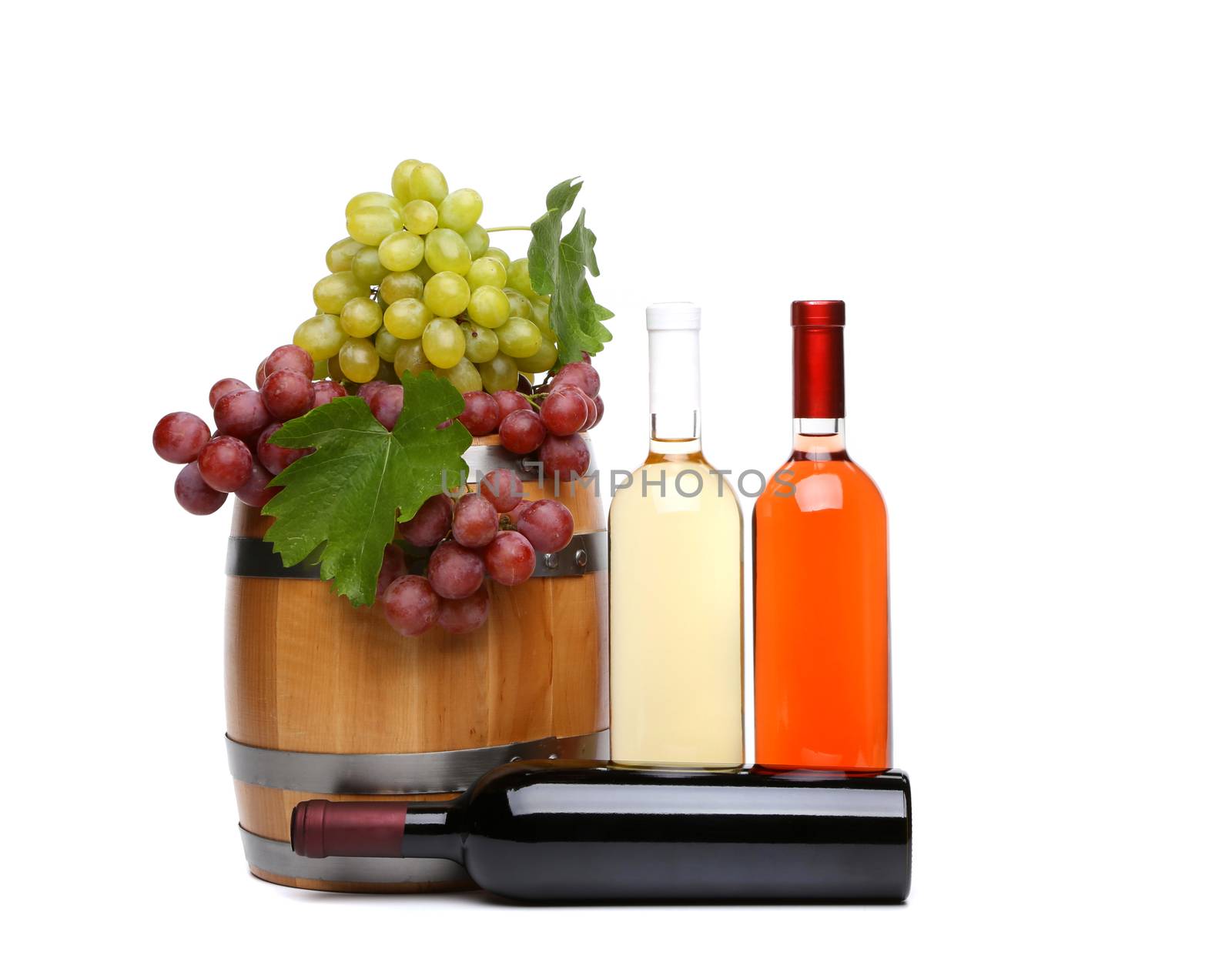 barrel and bottles of wine and ripe grapes on barrel