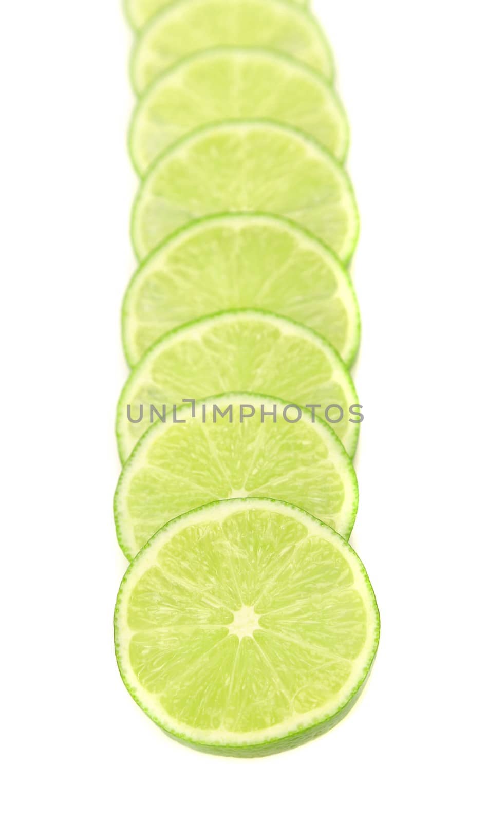 Row lime slices on a white background