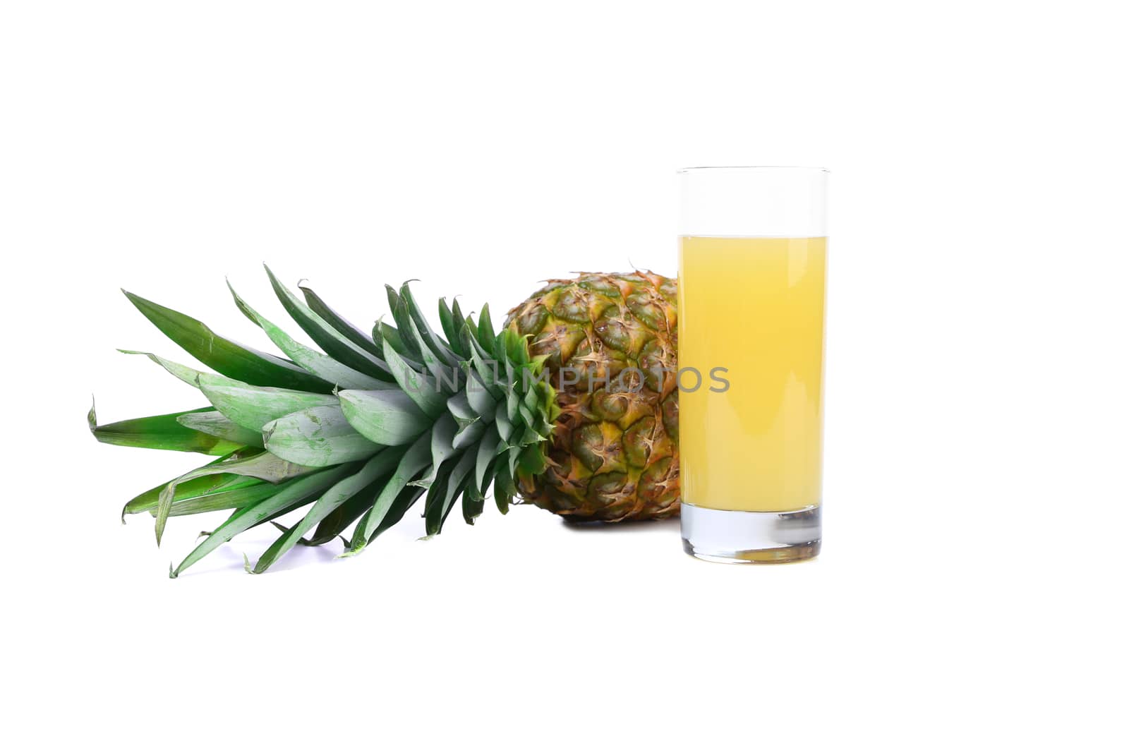 Ripe pineapple and juice glass isolated on a white background