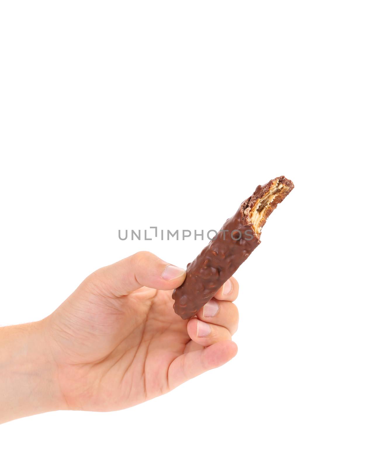 Hand holds bitten chocolate bar. White background.