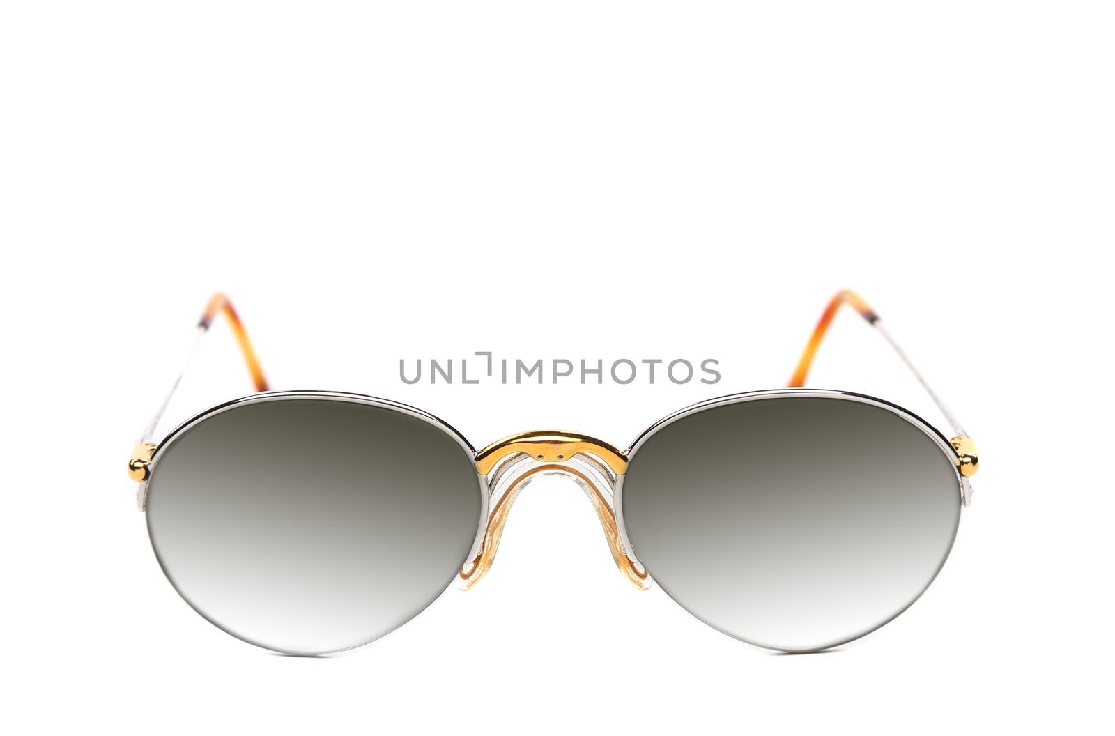 Sunglasses of yellow and white gold on a white background.