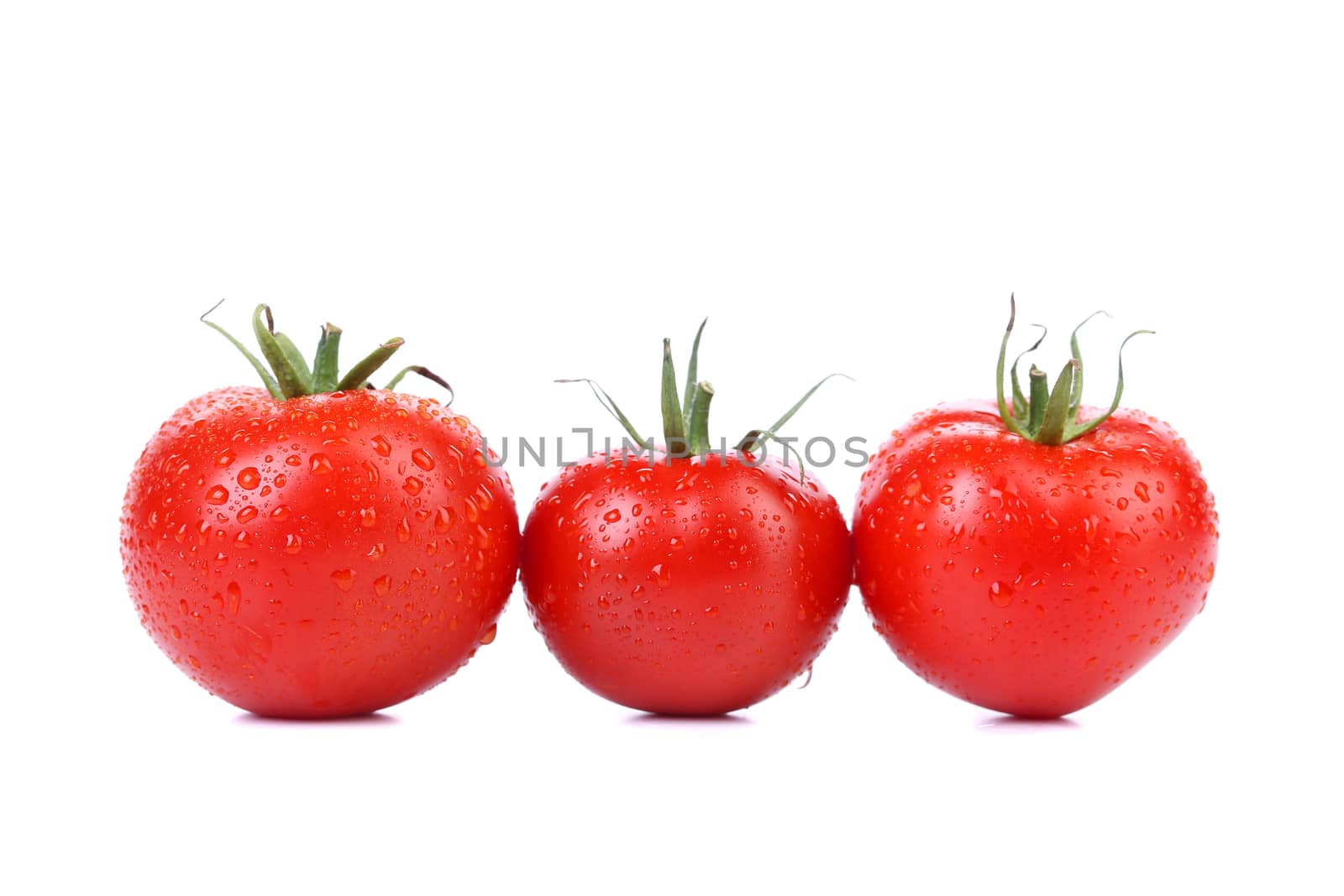 Three tomatoes isolated on a white background.