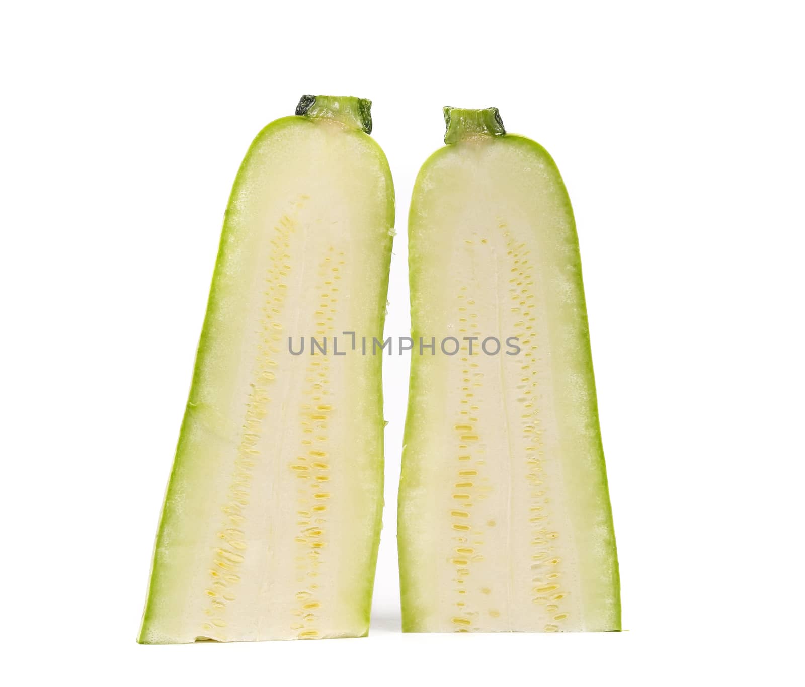 Couple of half zucchini cut along. White background.
