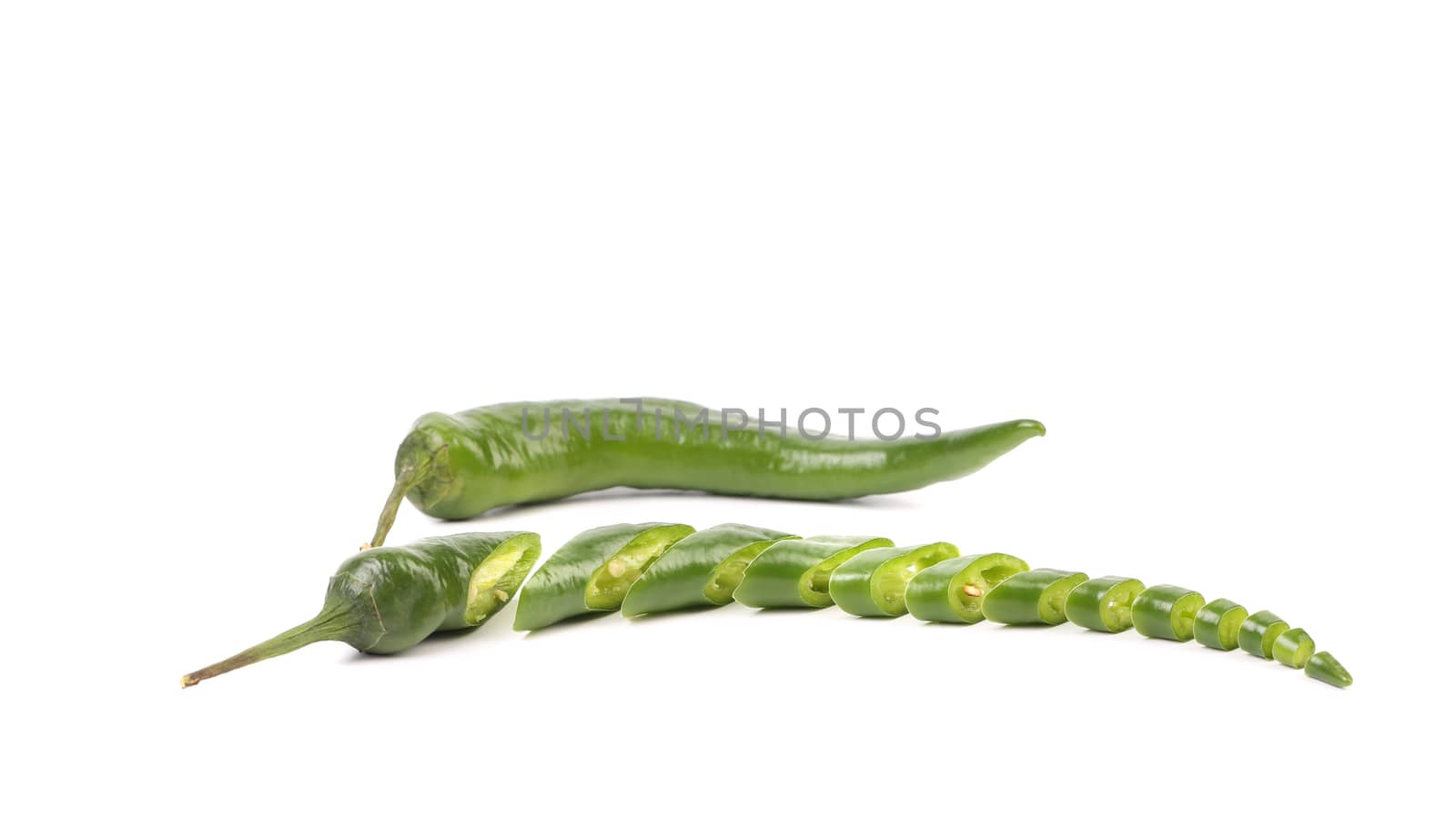 Green chilli pepper and slices isolated on a white background