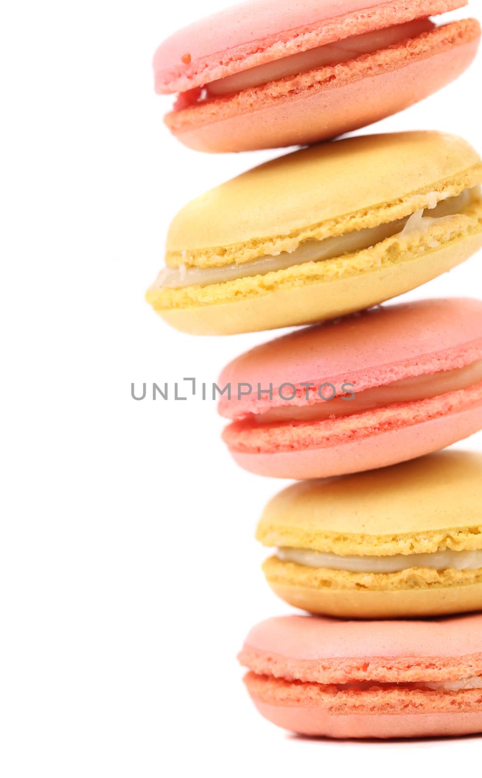 Stack of traditional French macarons against a white background.