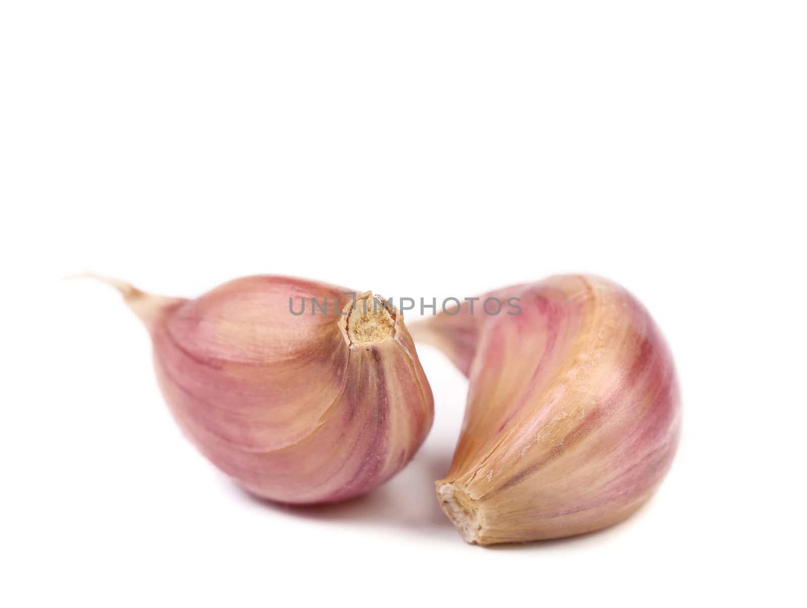 Red garlic cloves isolated on white background