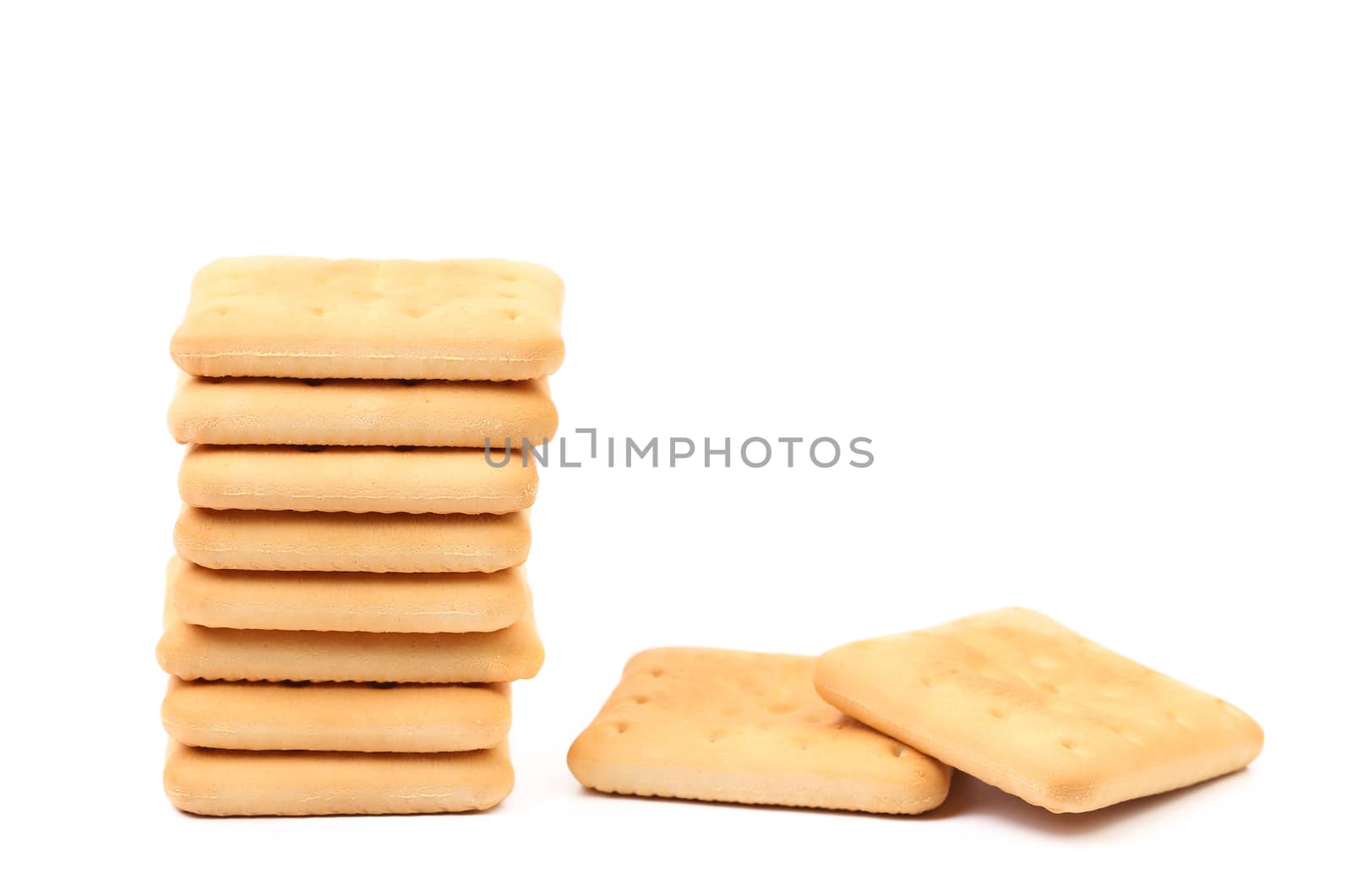 Stack of saltine soda crackers isolated on white