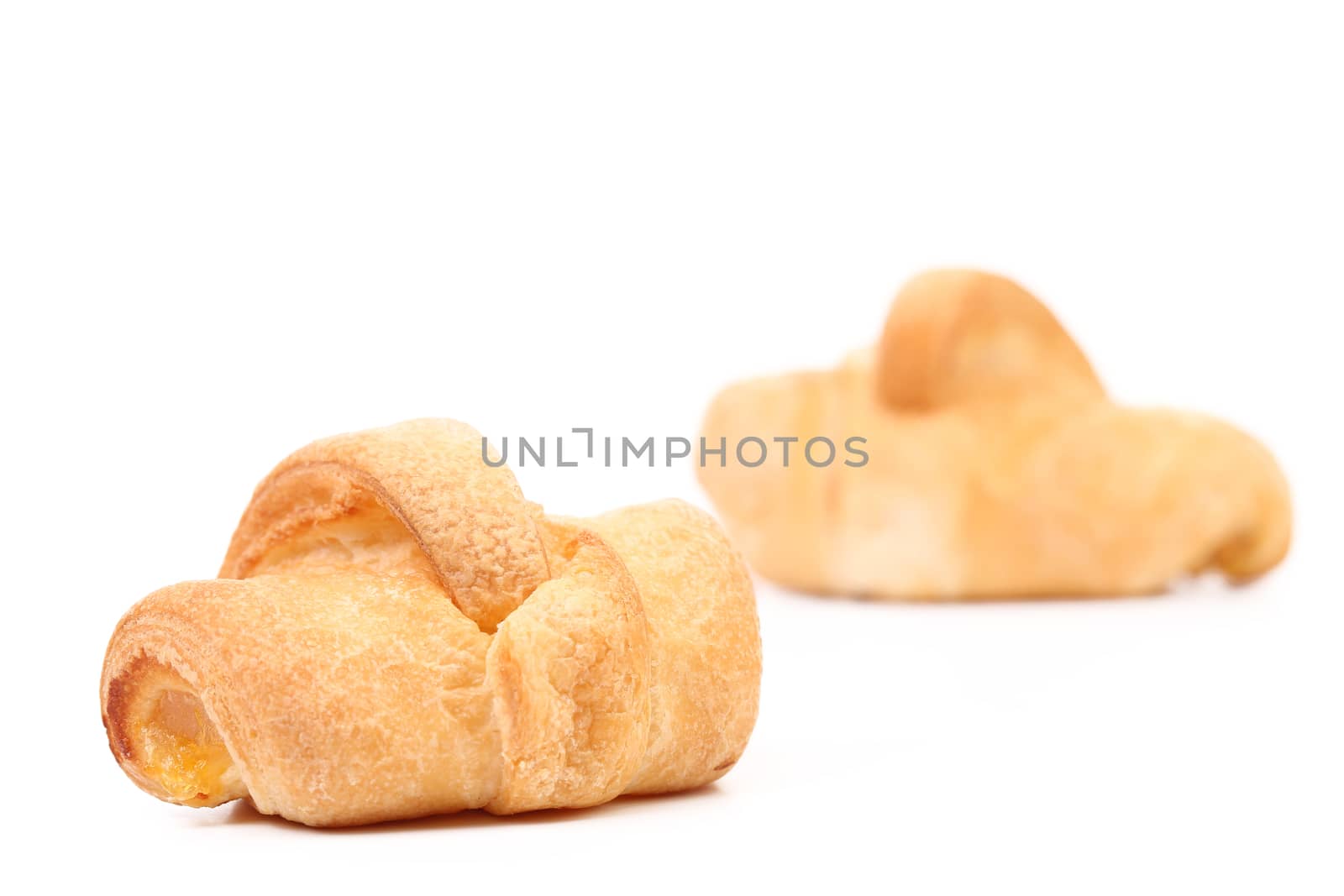 Two croissants on a white background. Close up.