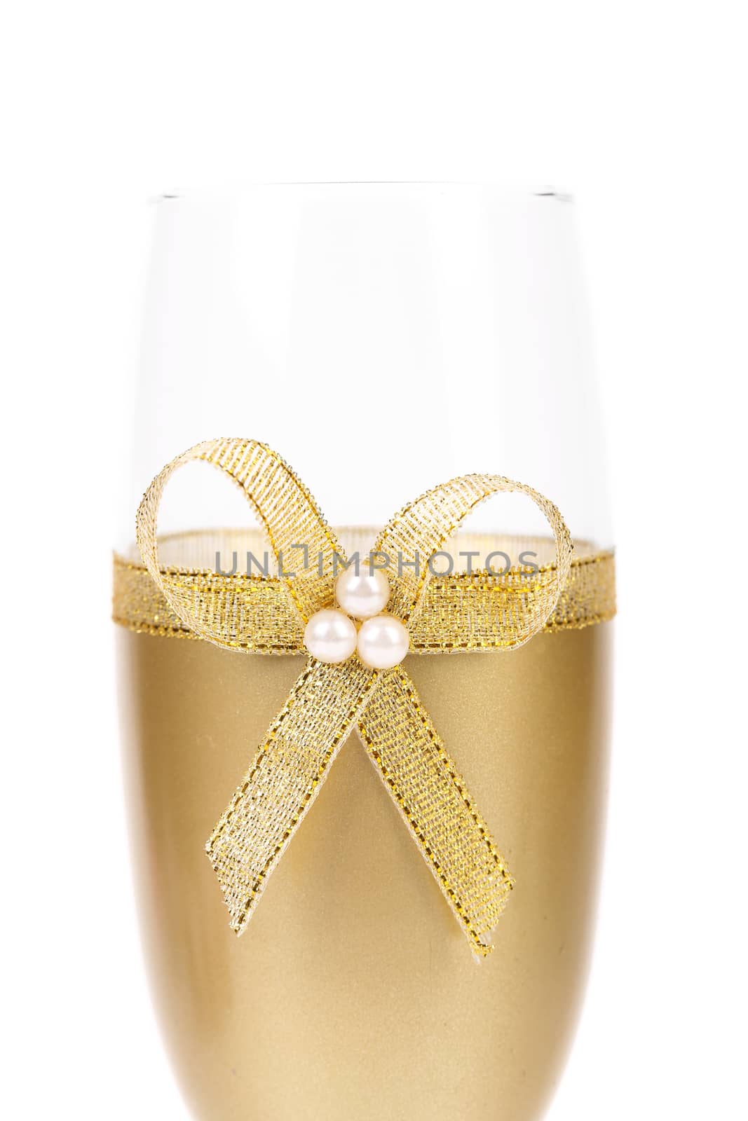 Decorated wedding golden glass wuth bow. White background.