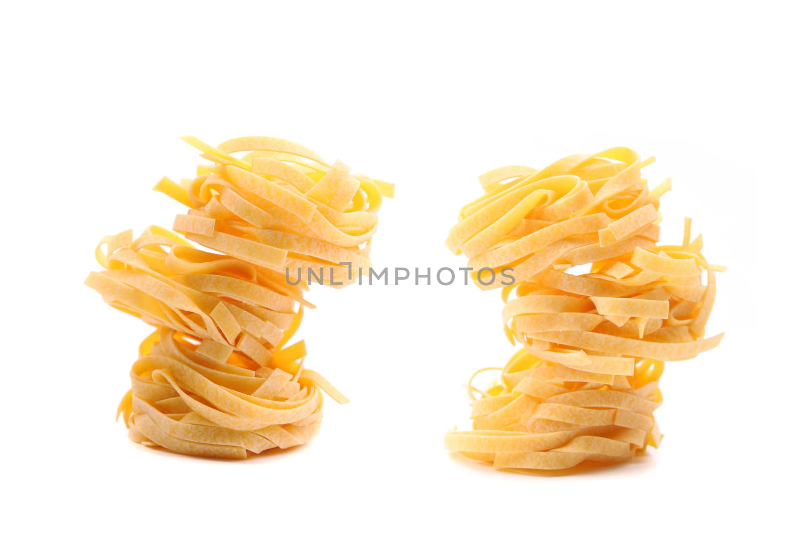 Tagliatelle paglia e fieno homemade tipycal italian pasta close-up on the white background