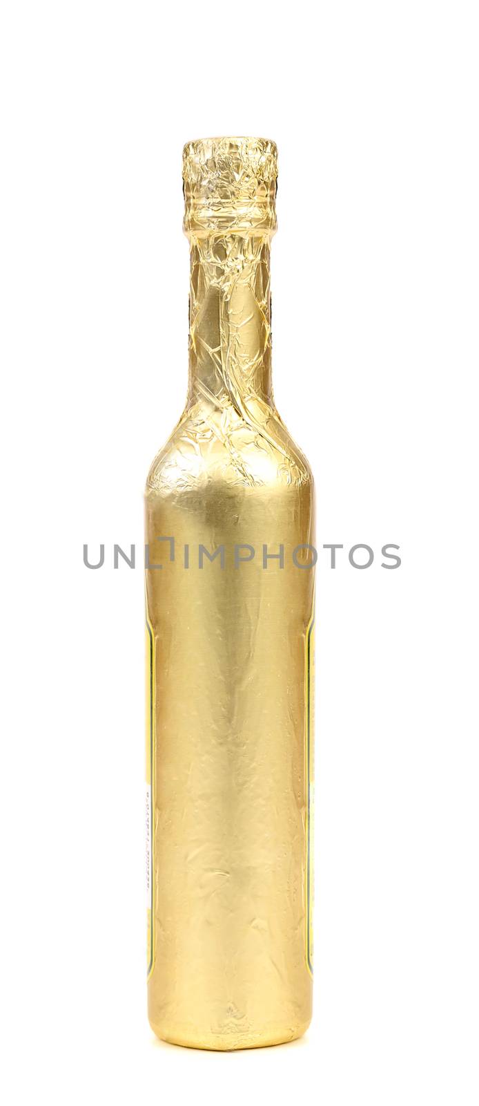 Bottle wrapped with gold foil. White background.