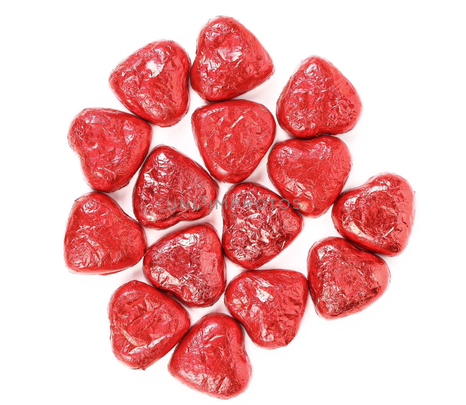 Red chocolate hearts candies on a white background