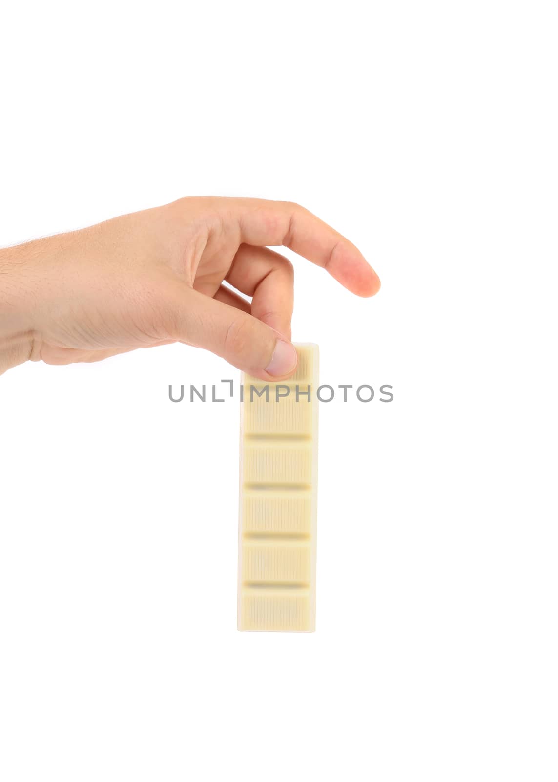 Hand holds white chocolate bar with filling. White background.
