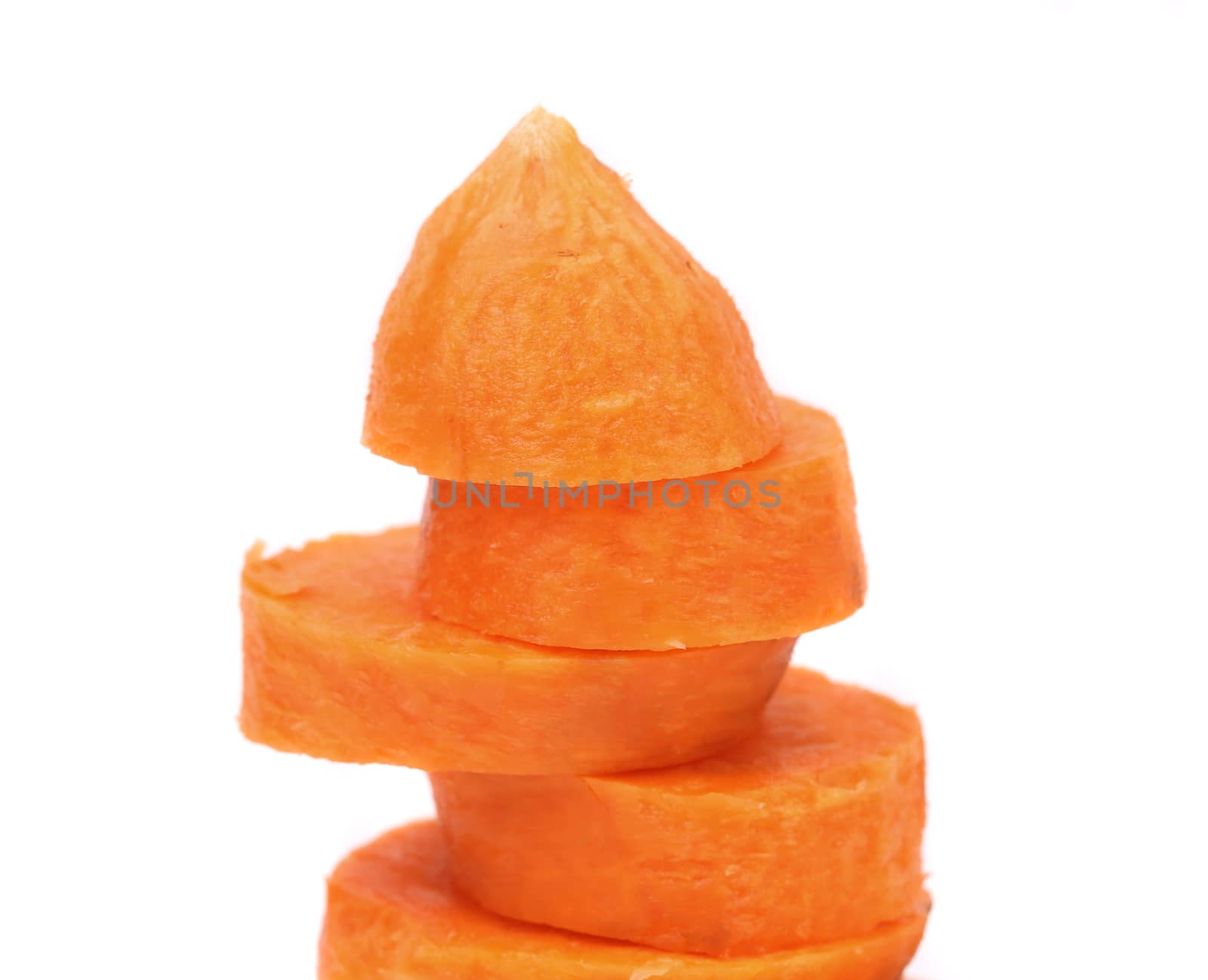 fresh carrot slices stack up on a white background