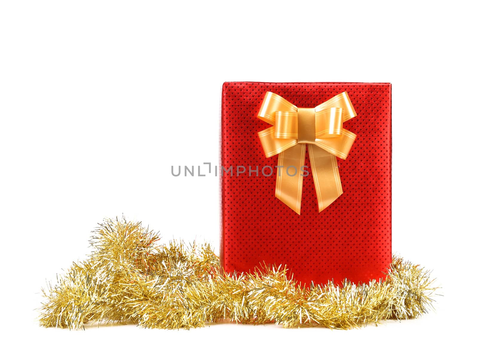 Red present box with spots and golden bow. White background.