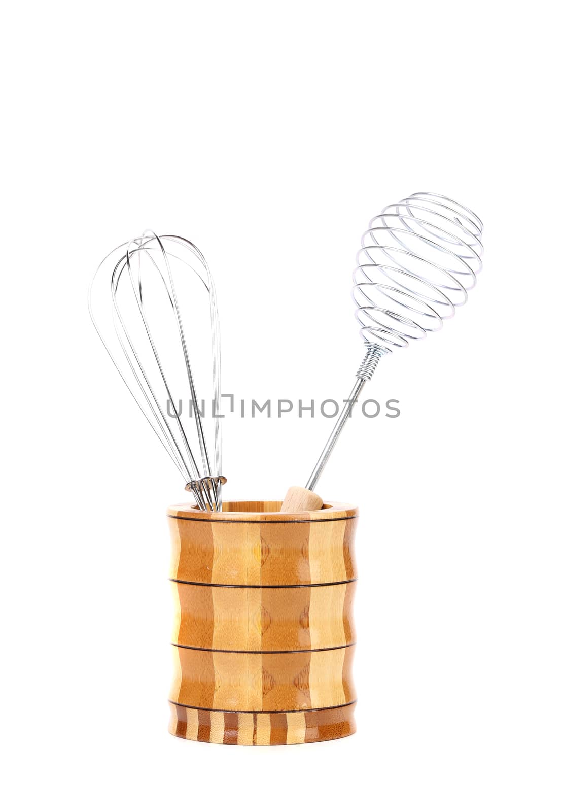 Two different whisks in wooden jar. White background.