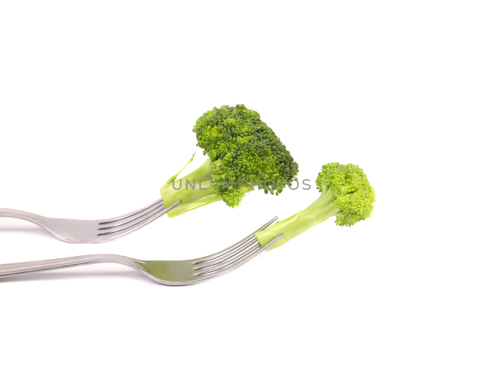 Different broccolies on two forks. White background.